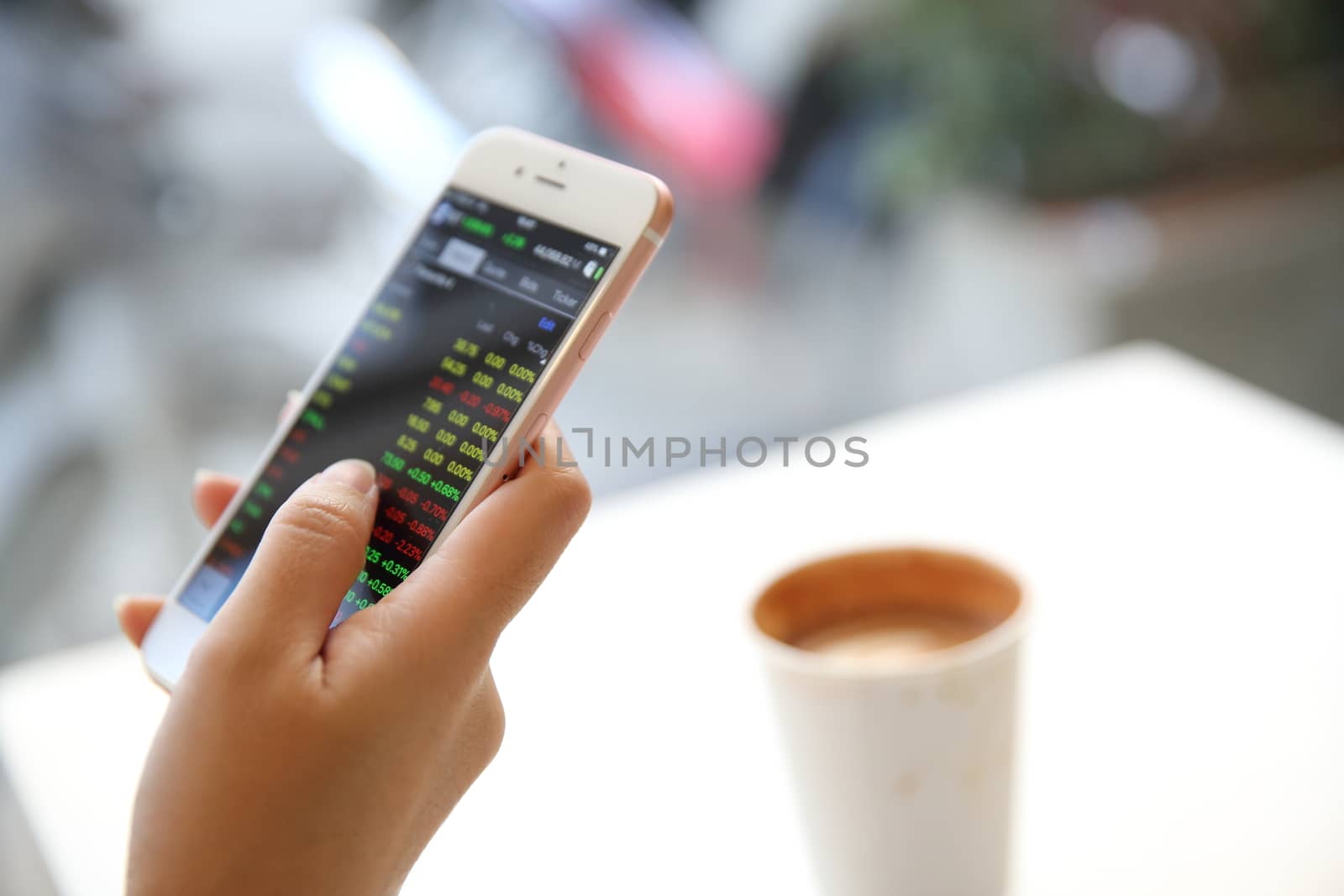 business trading online on smartphone with woman hand by piyato