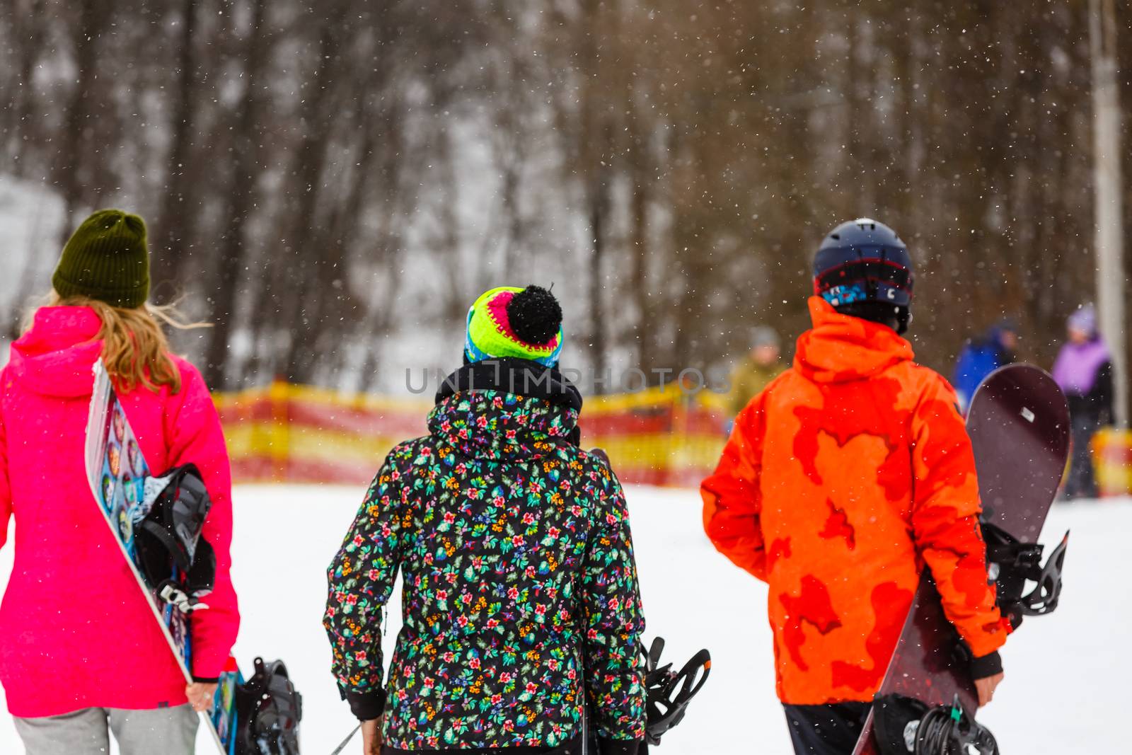 Happy friends going in winter vacation. Young people having fun doing extreme snowboarding by Andelov13