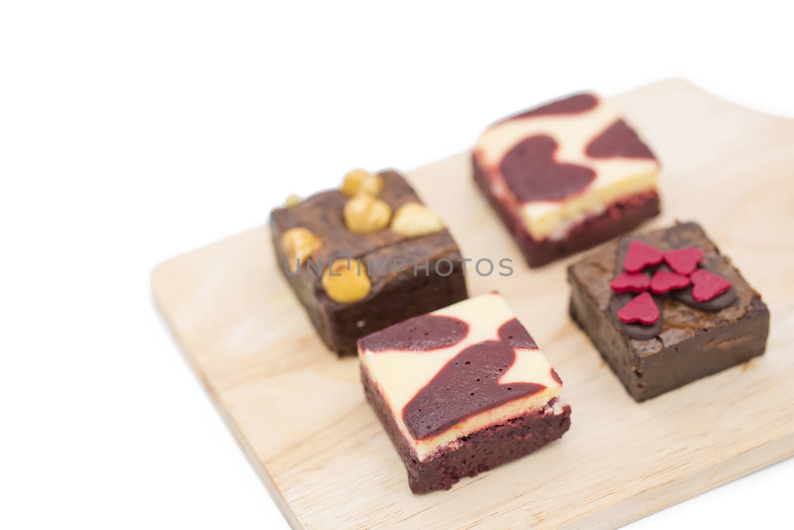 mini brownie on wooden board isolated on white background.