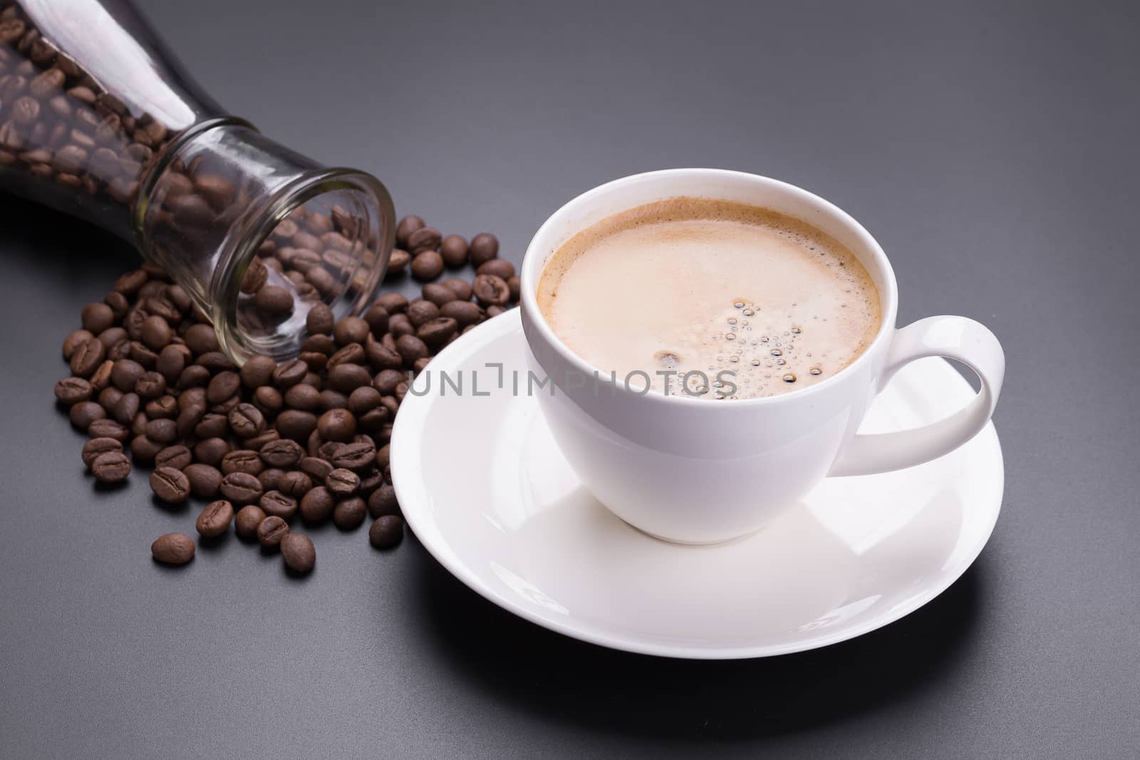 Hot americano coffee in white glass on black background.