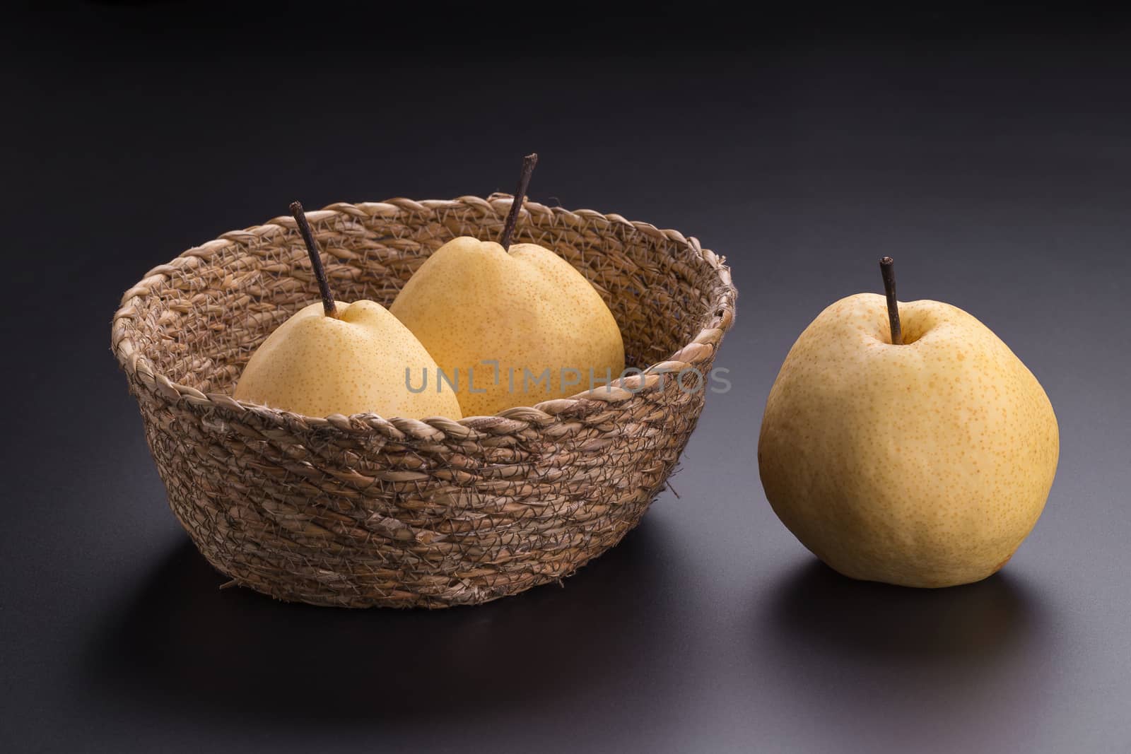 Chinese pear fruits on black background by kaiskynet