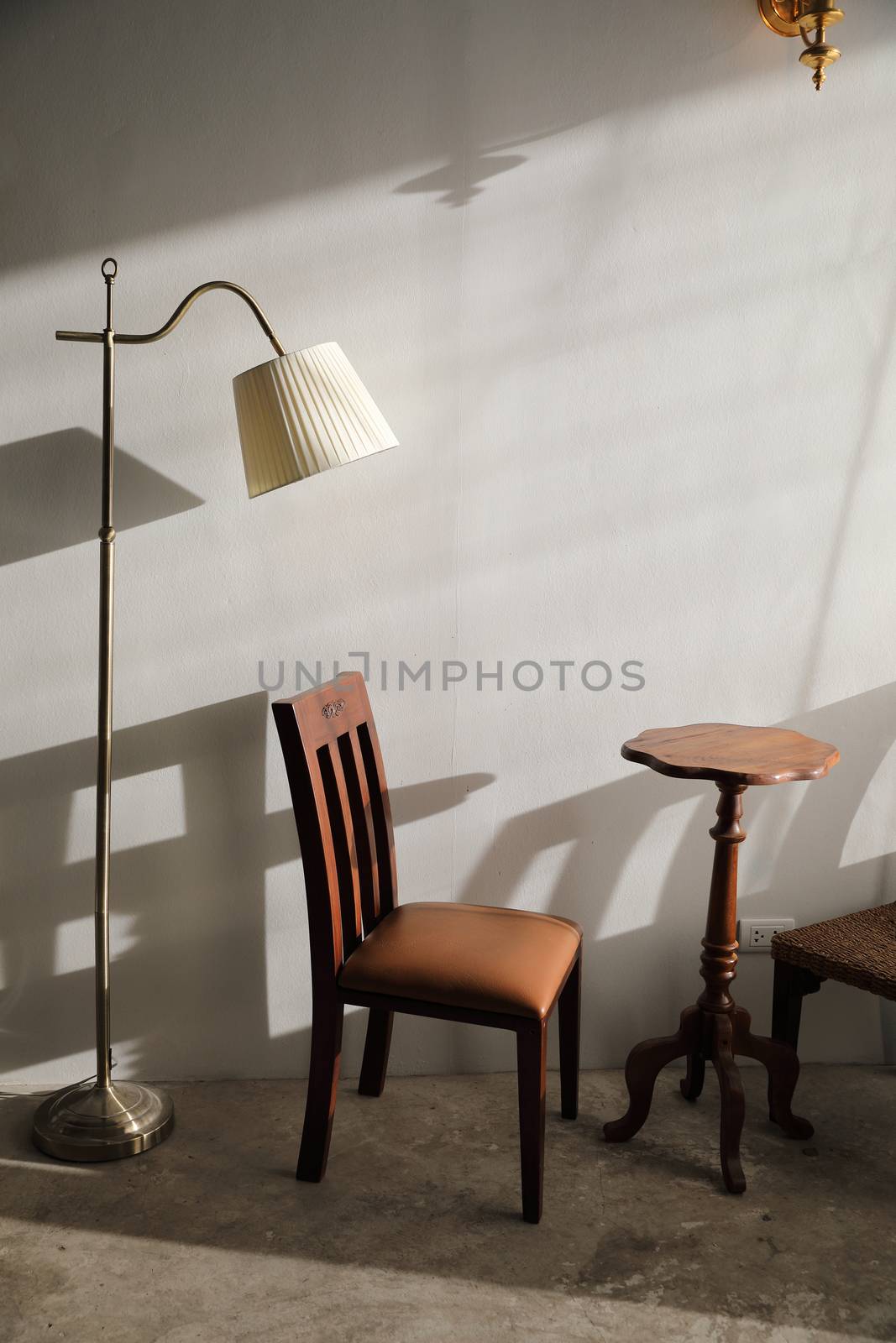 Wooden table and chairs with lamp on wall