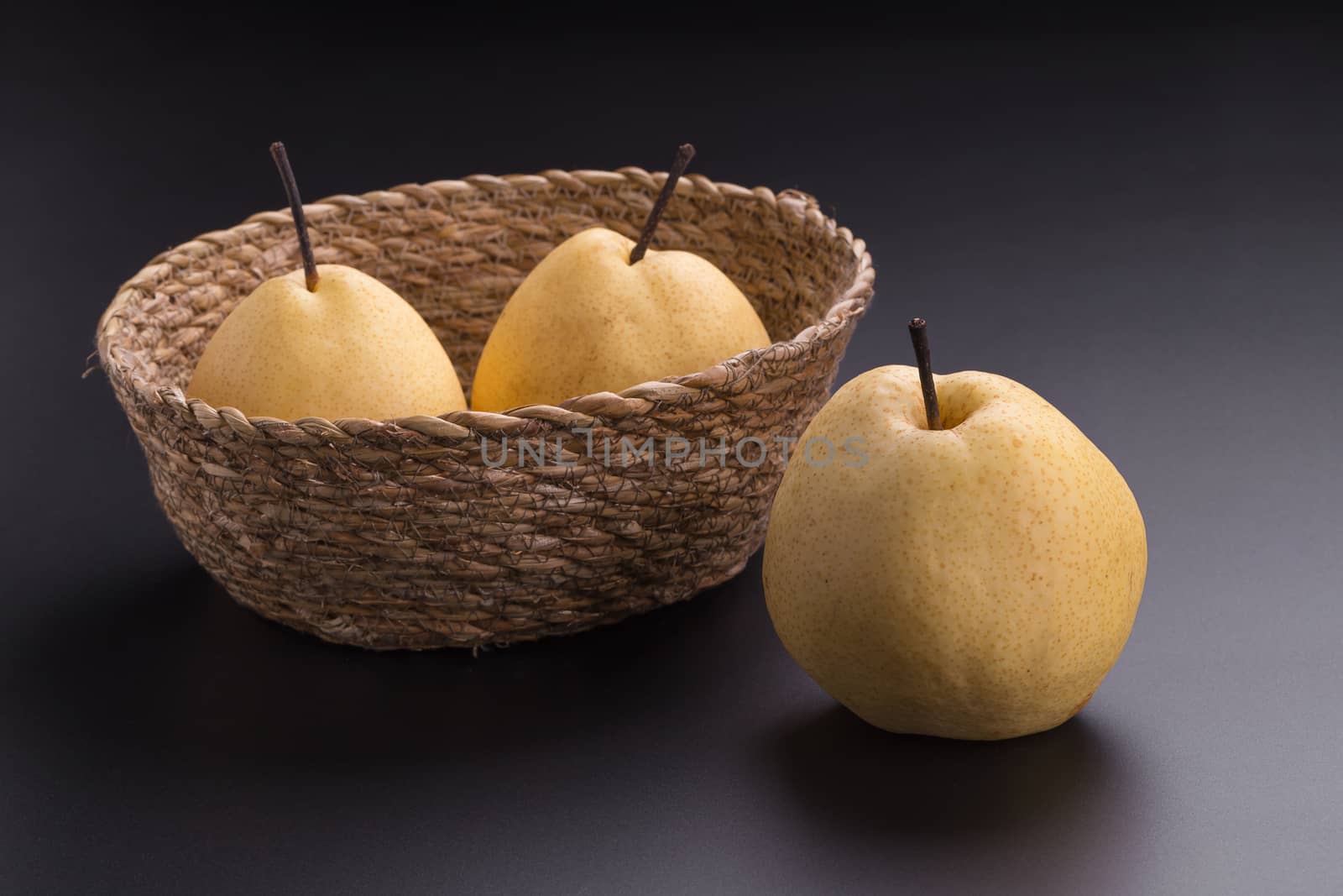 Chinese pear fruits on black background by kaiskynet