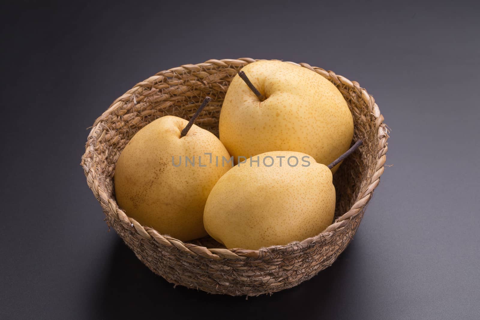 Chinese pear fruits on black background.