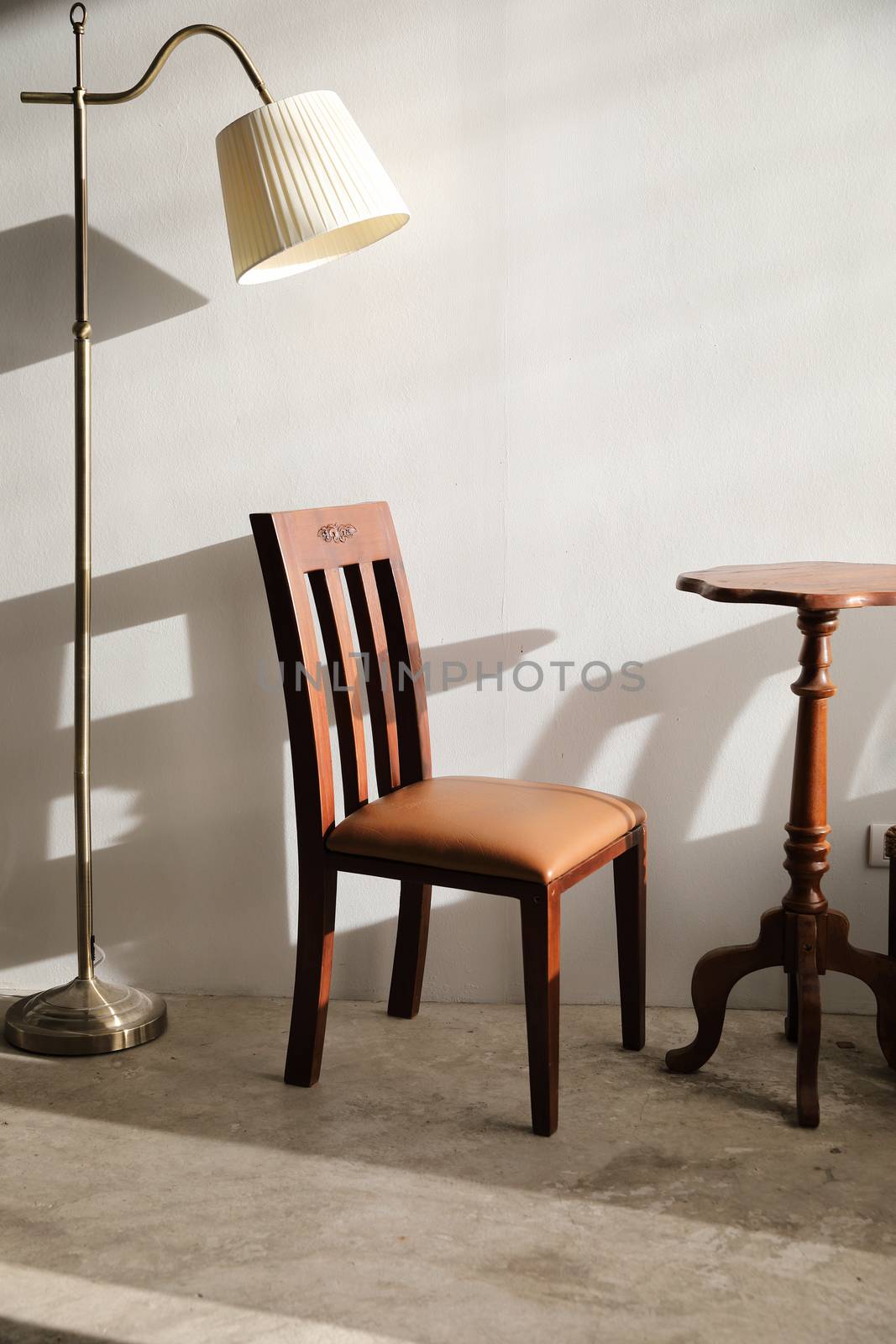 Wooden table and chairs with lamp on wall