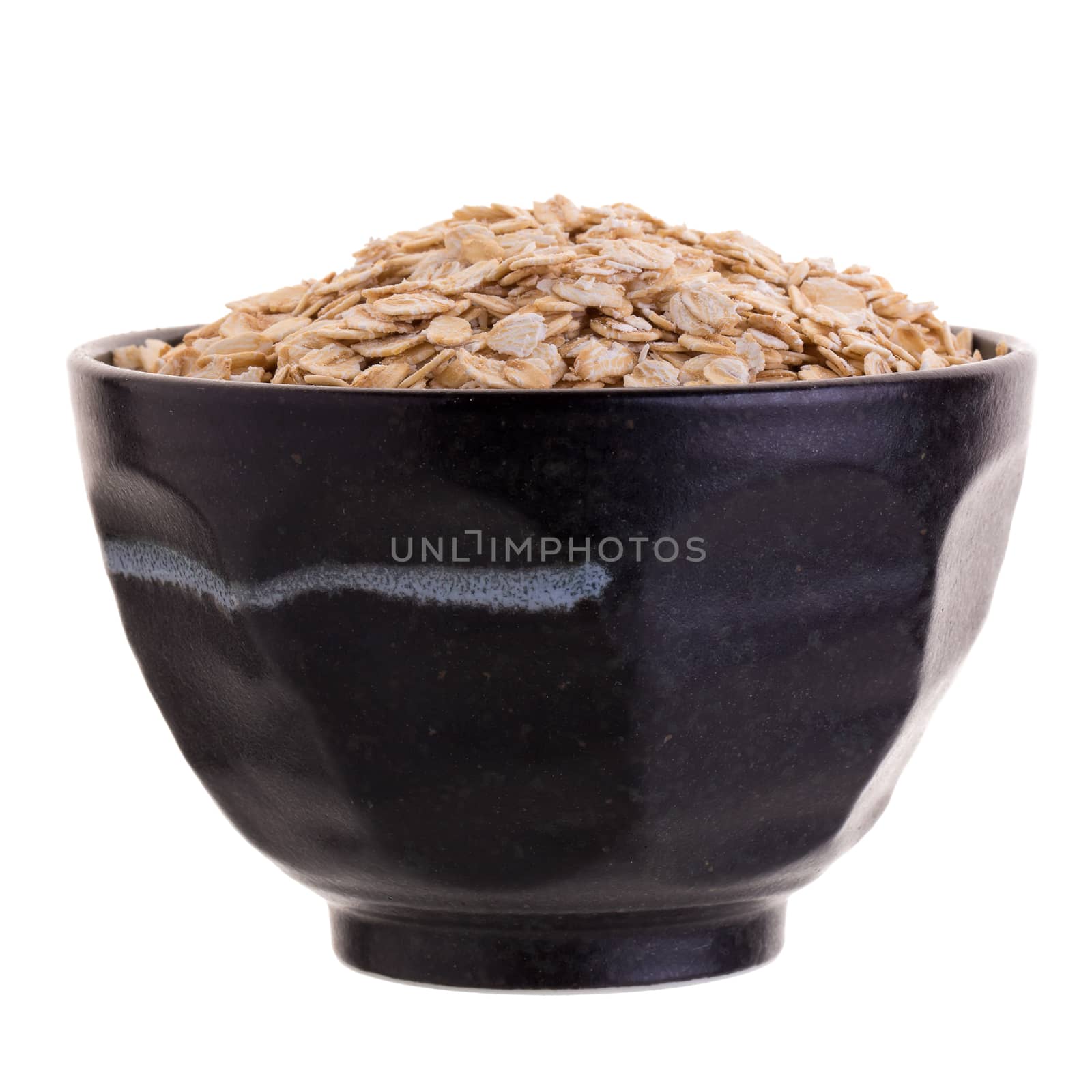 Oat in Black bowl isolated on a white background.