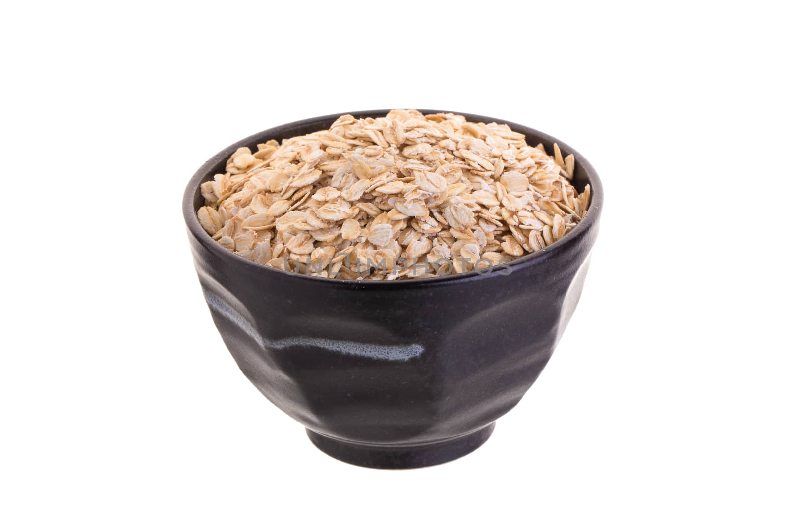 Oat in Black bowl isolated on a white background.