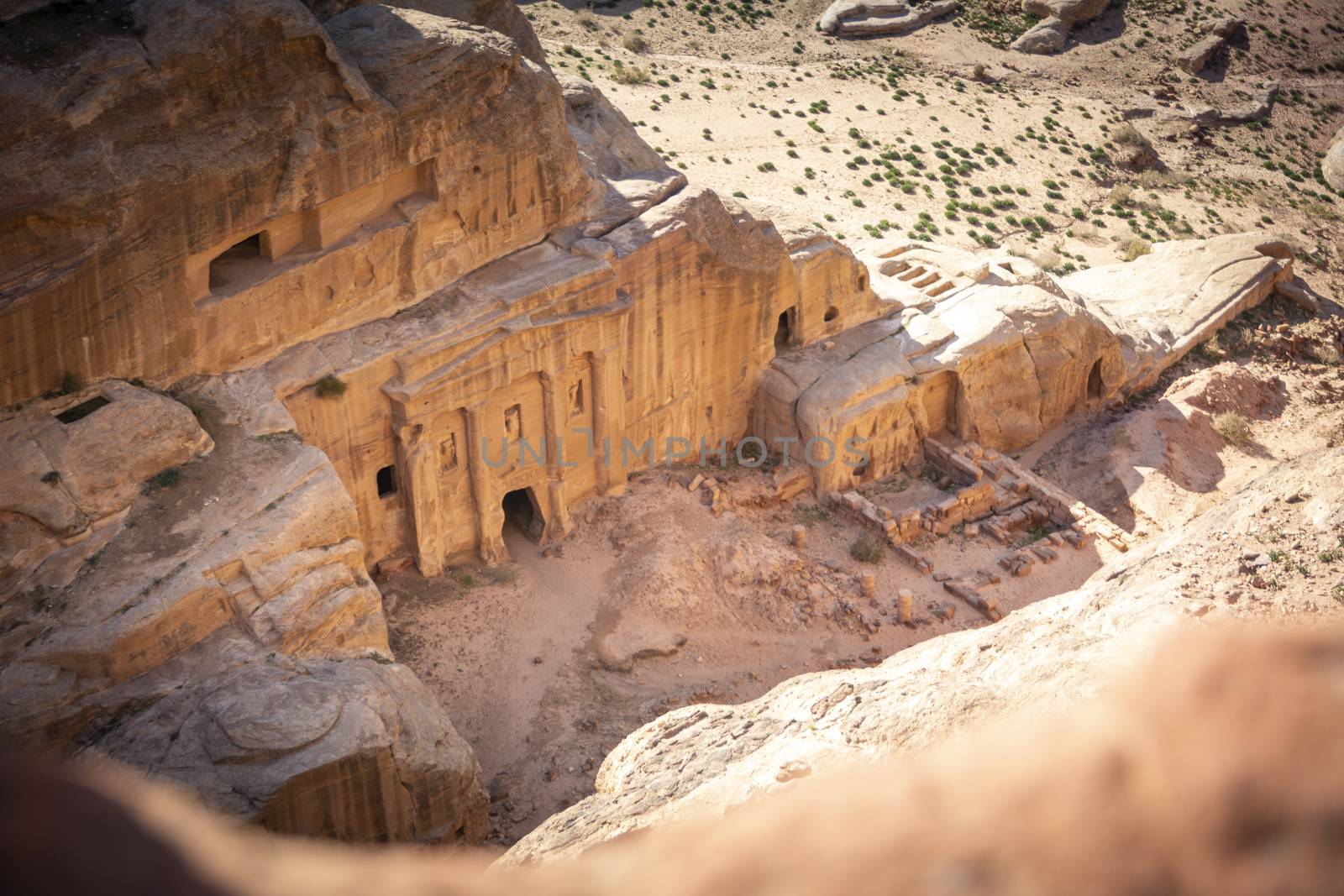 View on the Renaissance Tomb in Petra Jordan, on the High Place of Sacrifice Trail. View from above, valley deep down below. Travel and Tourism in Jordan