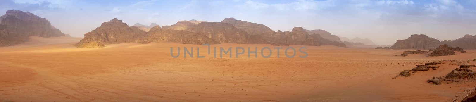 Panorama wide angle of an empty Wadi Rum desert in spring, with some clouds in the air. by kb79