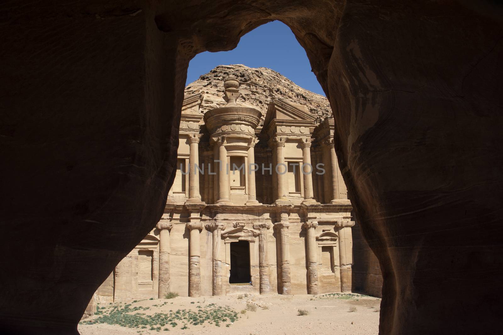 View on the Monastery, Ad Deir, of the historical city of Petra, Jordan, as seen from the inside of a bedouin cave. by kb79