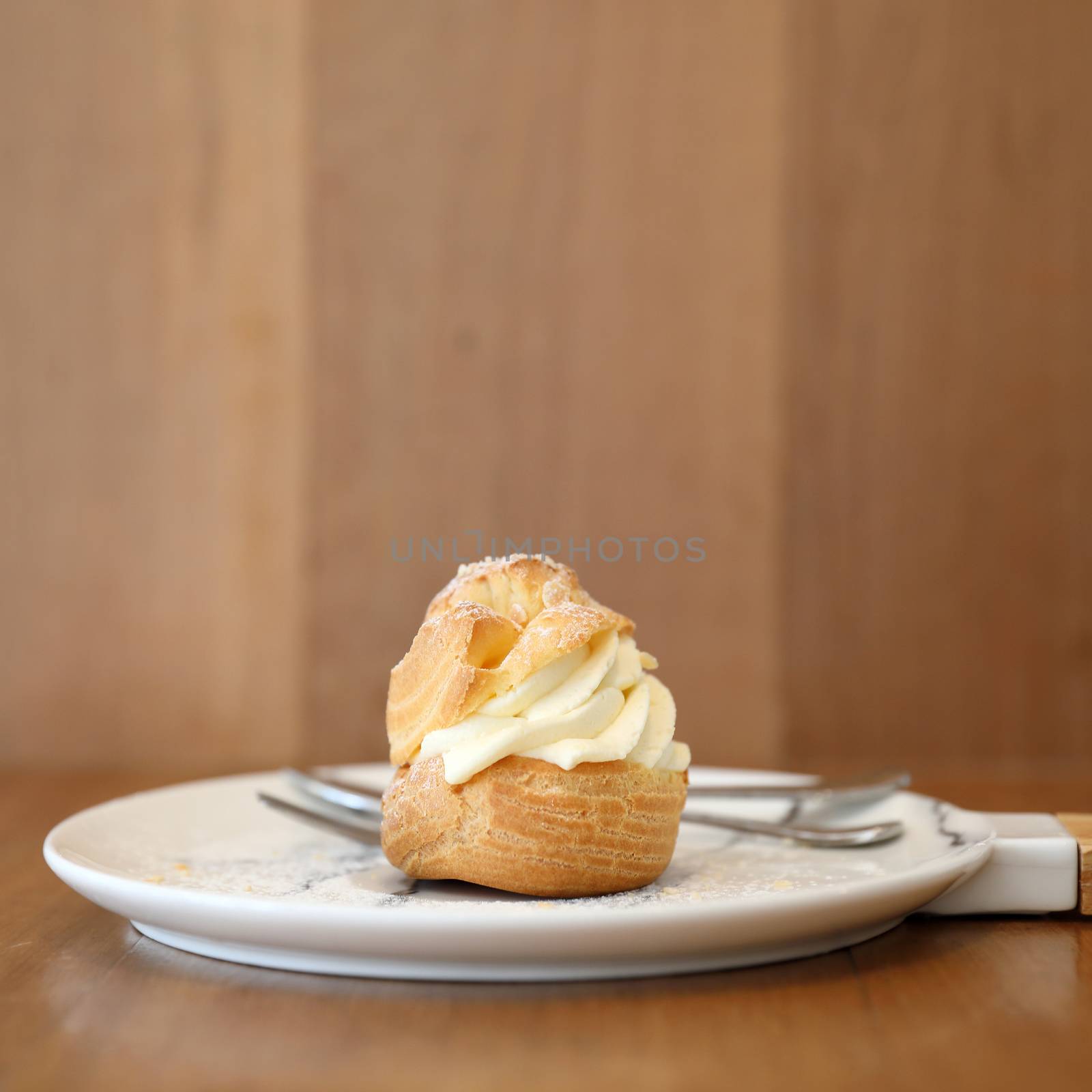choux cream on wooden table by piyato