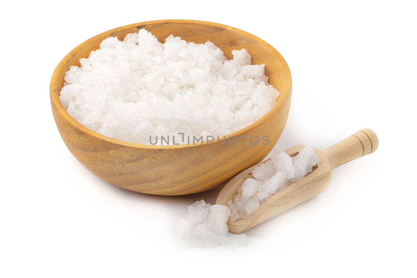 Organic sea white salt tablets in a wooden bowl on white background.