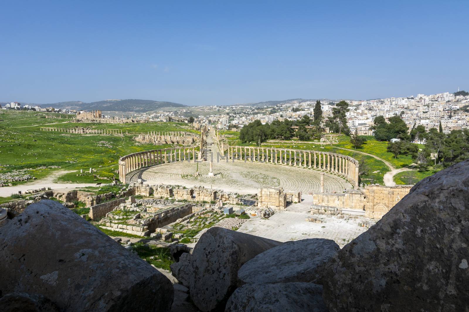 Greco-Roman ruins of Gerasa and the modern city of Jerash in the background. Oval Forum, Colonnaded Street and Cardo Maximus in clear view. by kb79