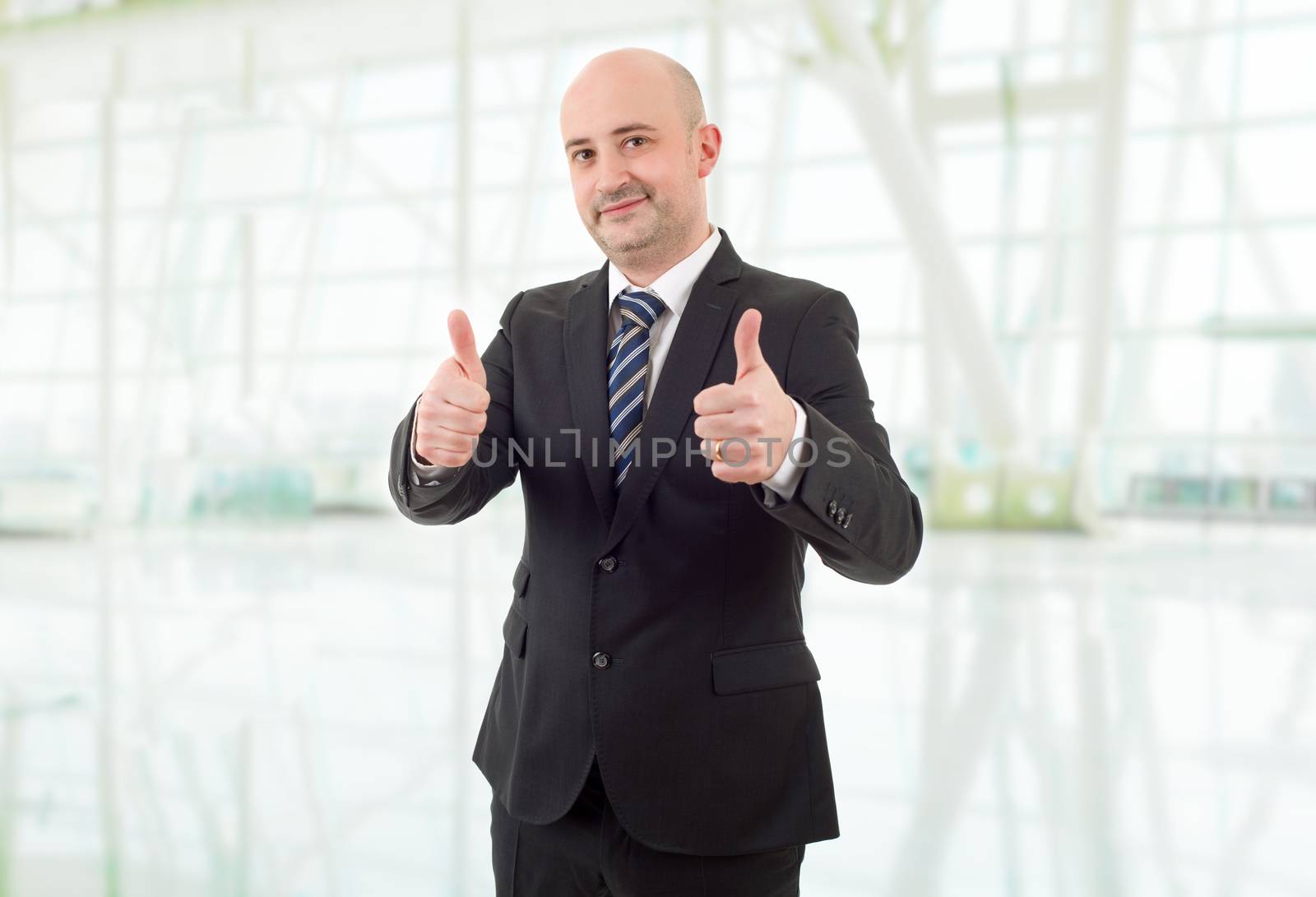 happy business man going thumbs up, at the office