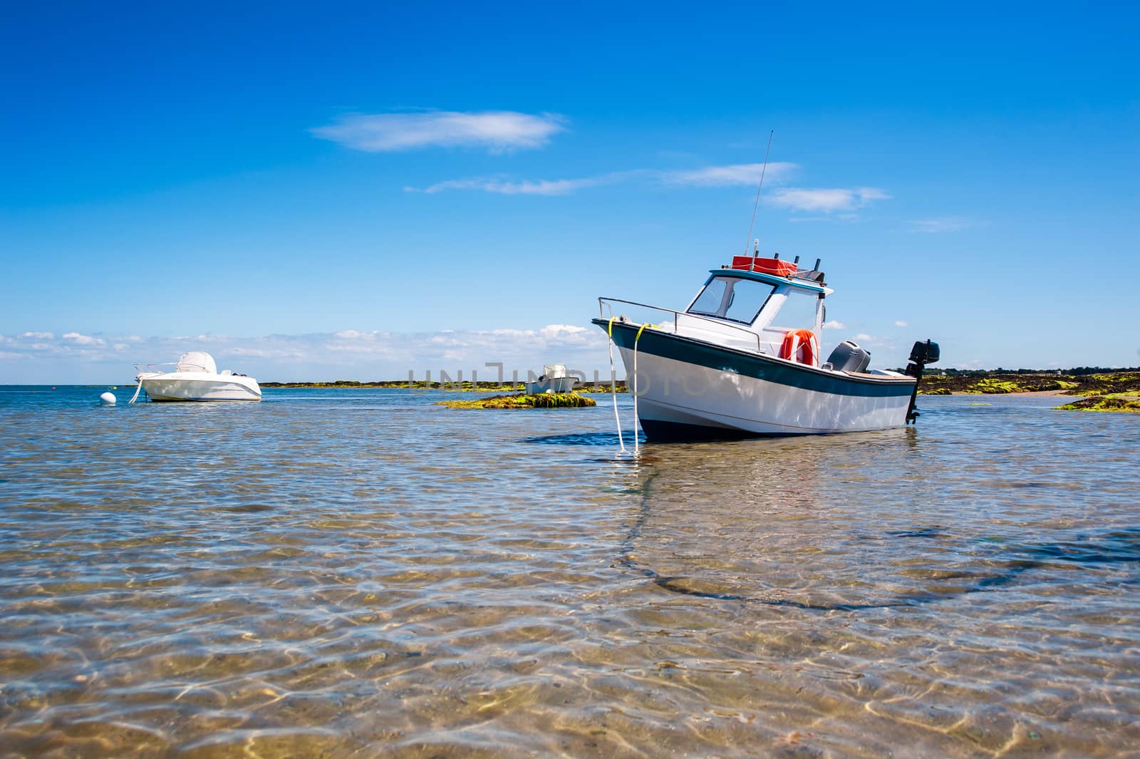 White boat on sand by Youri