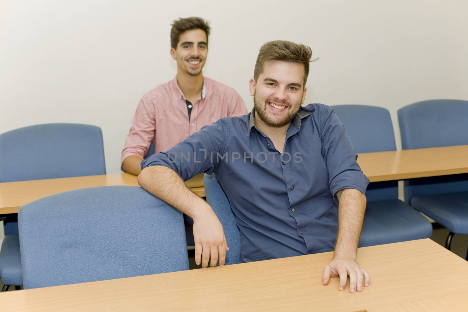 two young happy men at the classroom
