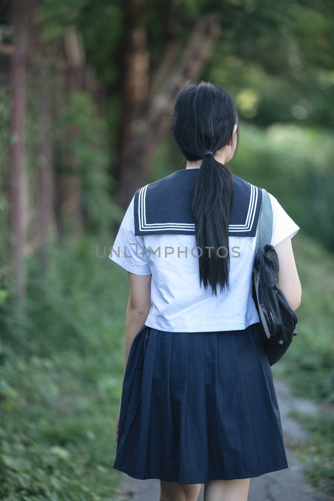 Portrait of asian japanese school girl costume looking at park outdoor film vintage style