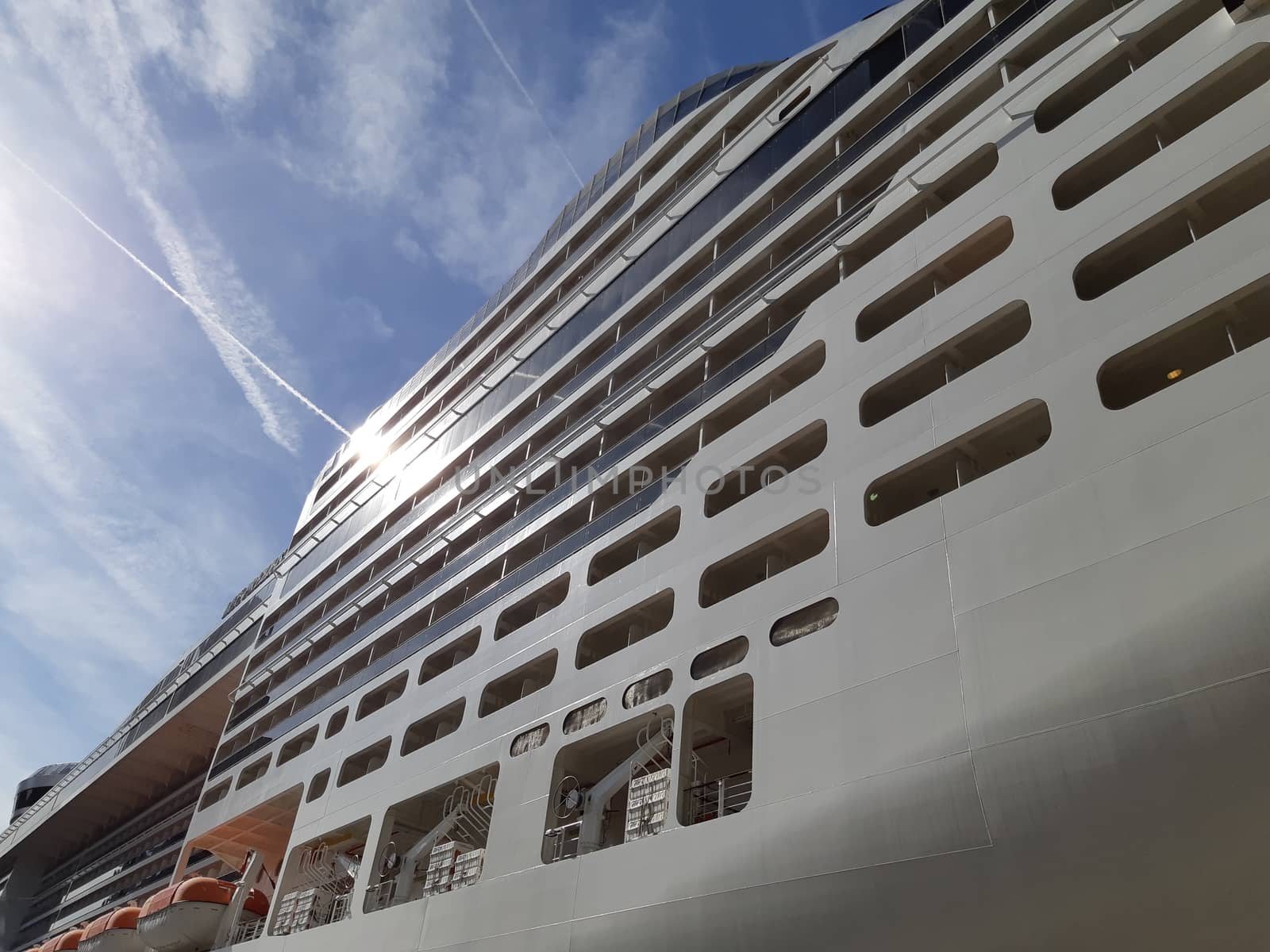 Side view of cruise ship on the blue sky background. Low angle view
