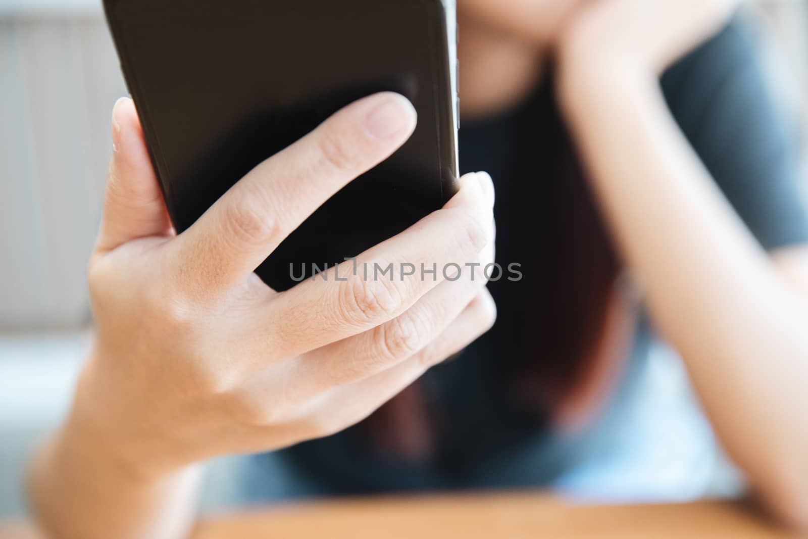 Woman hand using smart phone in business by piyato