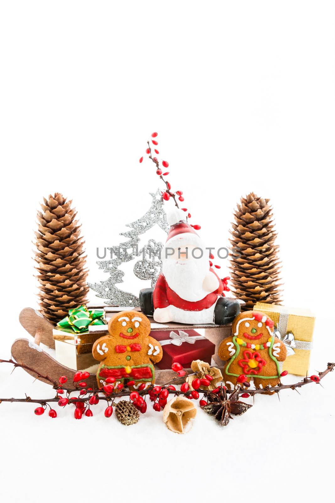 Close up of Santa sitting on wooden horse sledge holding gift and presents - white and red christmas background