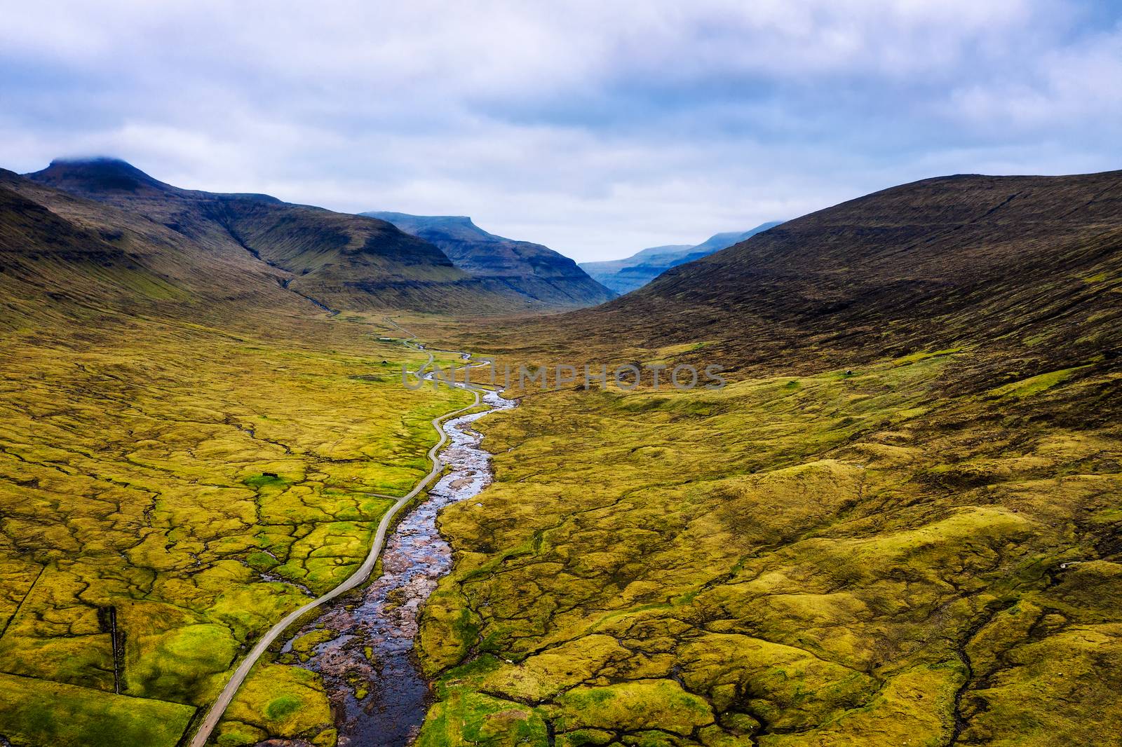 Aerial view of a road going to the village of Saksun on Faroe Islands surrounded by beatiful scenery.