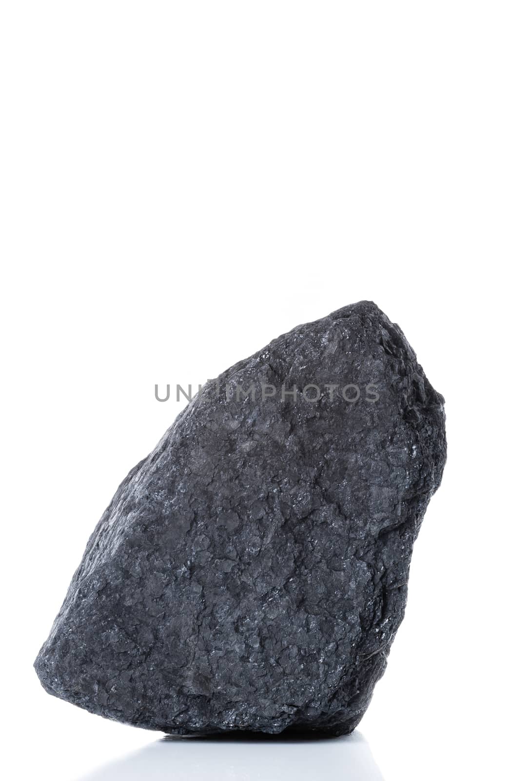 large piece of black bituminous coal on a white background