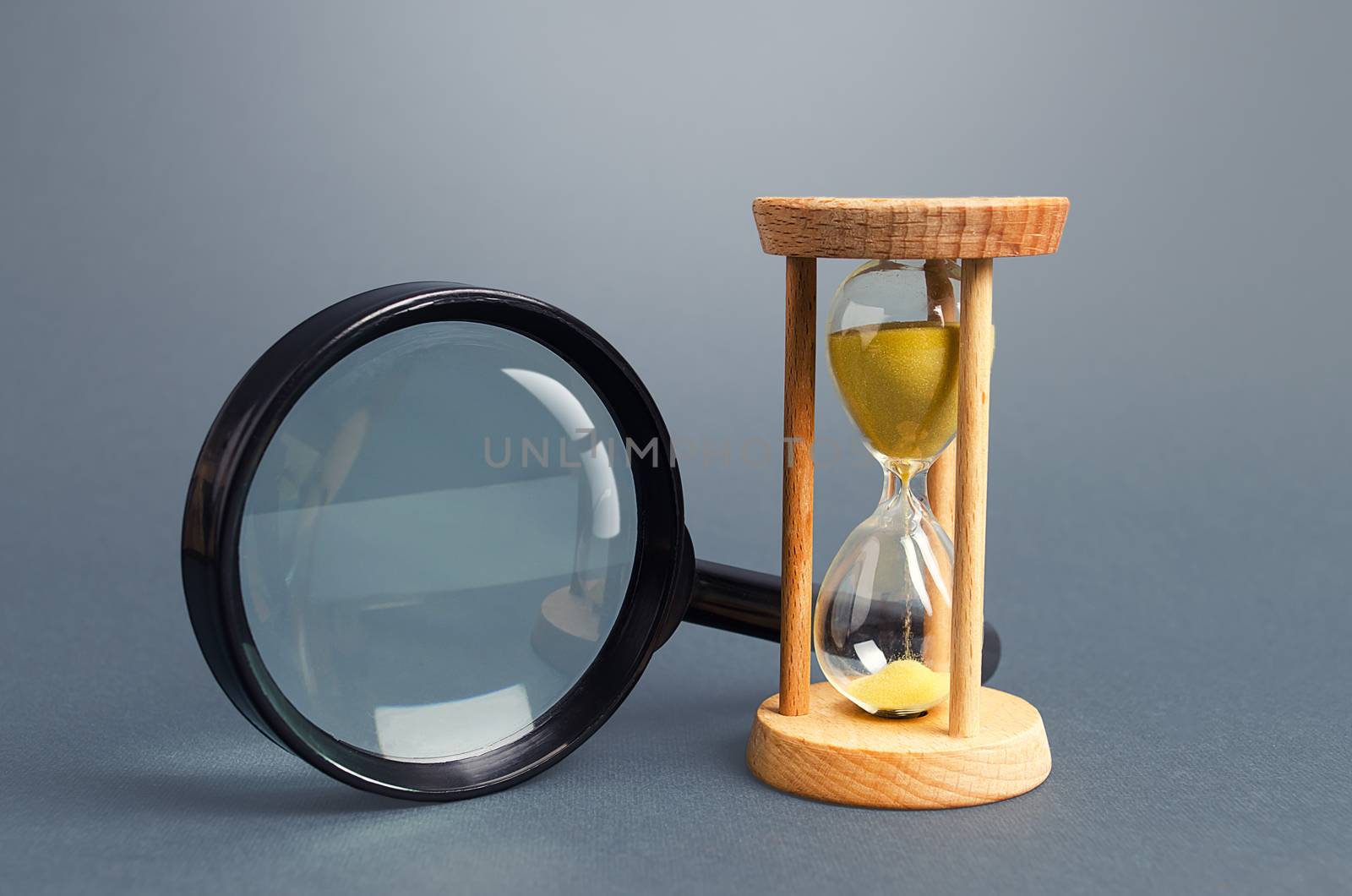 Magnifying glass and hourglass. Limited Search Concept. Find free time. Subscription, paid plan. Seek in short time. Speed and efficiency. Deadline