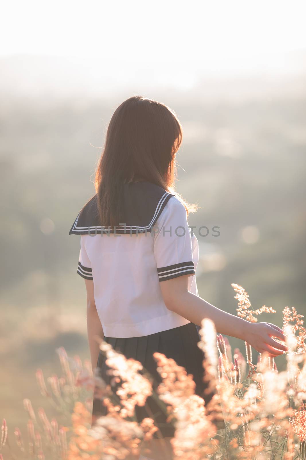 Portrait of asian japanese school girl costume looking at park o by piyato