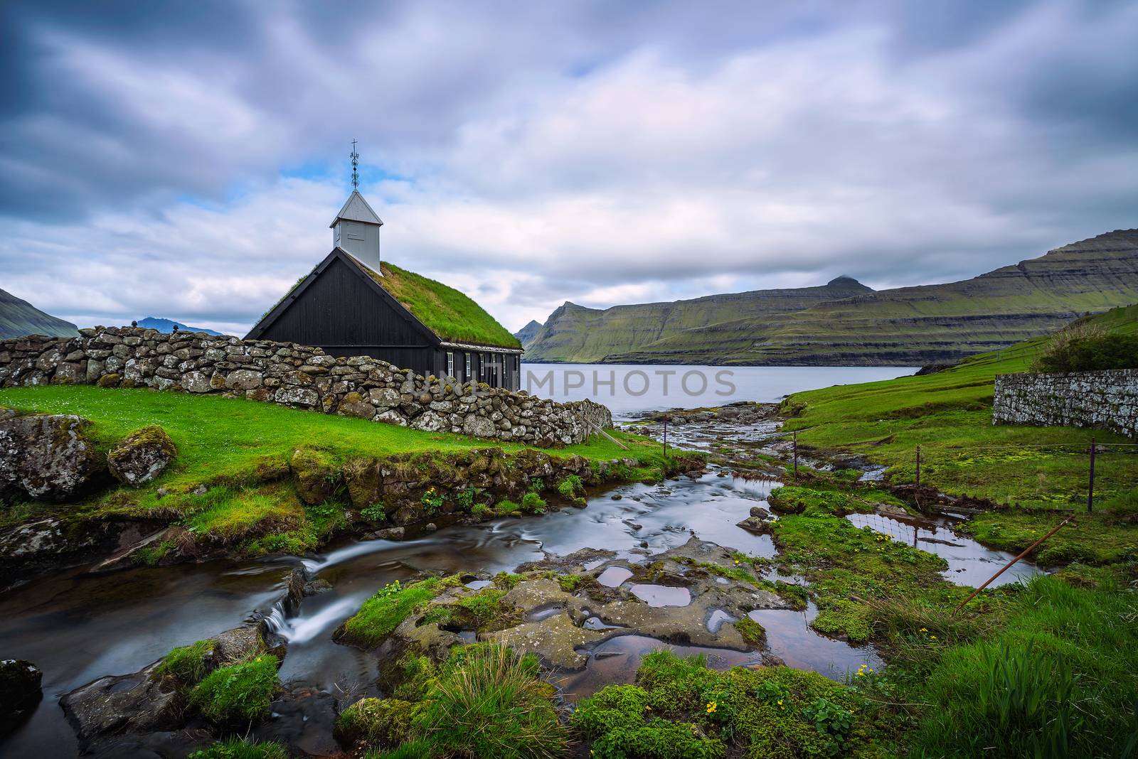 Small wooden village church on the sea shore in Faroe Islands, Denmark by nickfox