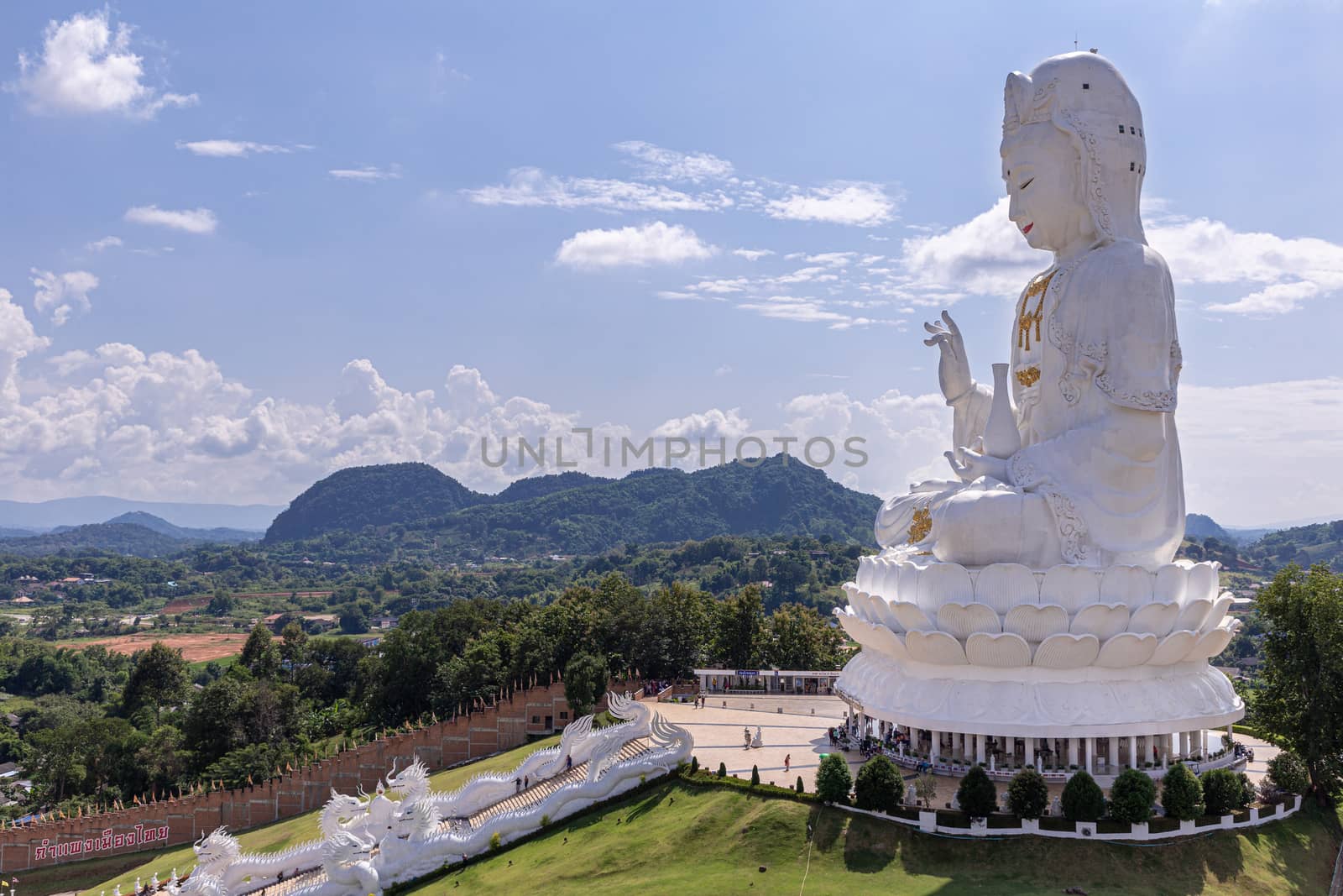 Guan Yin statue with blue sky and clouds sky at Huay Pla Kang Temple, Chiangrai, Thailand.
