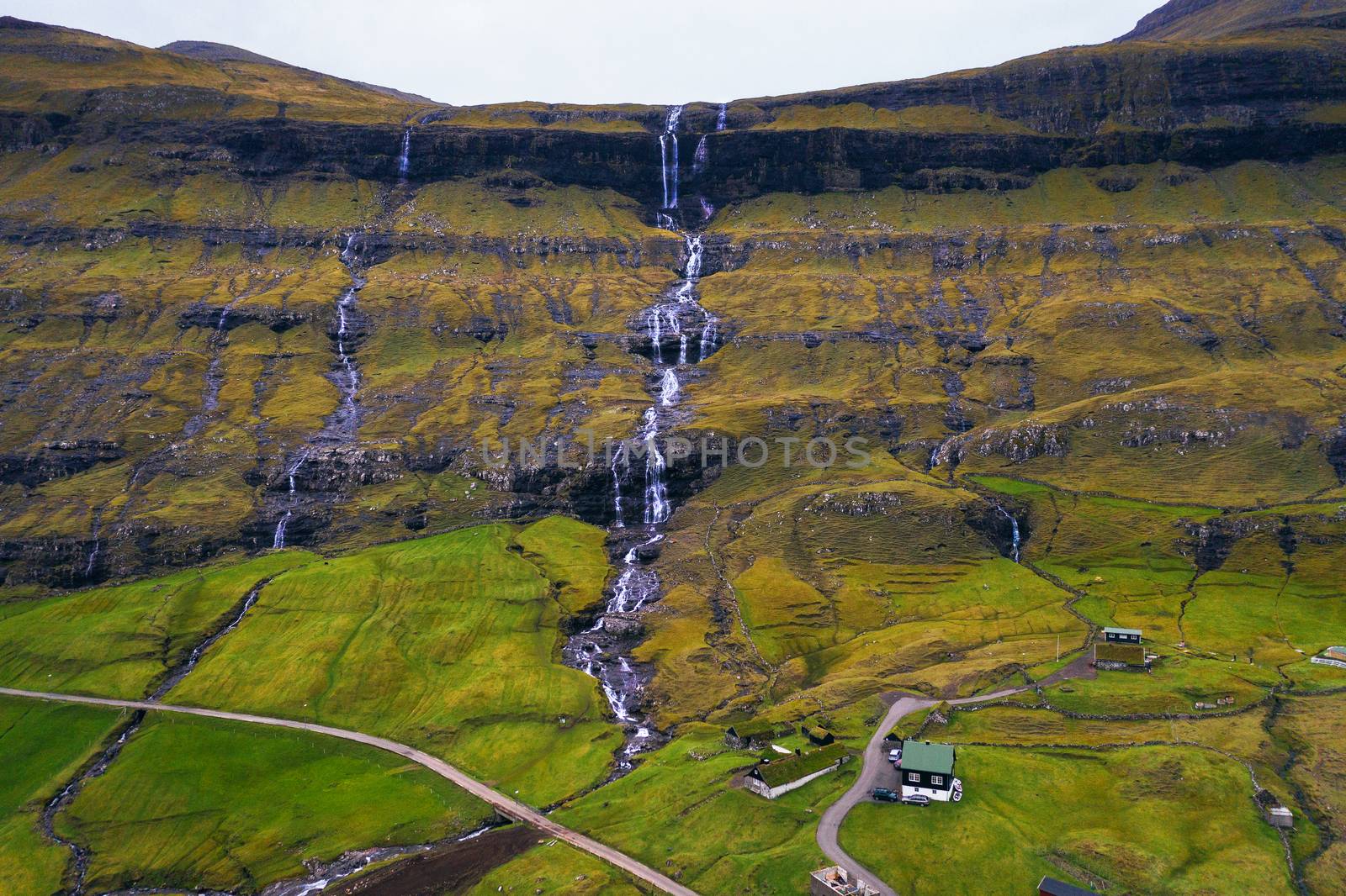 Aerial view of waterfalls in the village of Saksun on the Faroe islands by nickfox