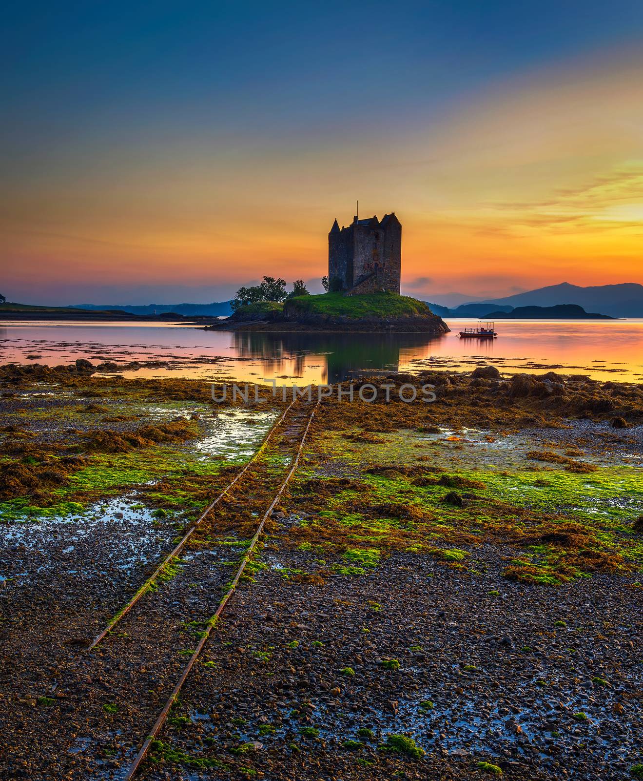 Sunset over Castle Stalker on Loch Appin located in Scotland, United Kingdom. Long exposure.