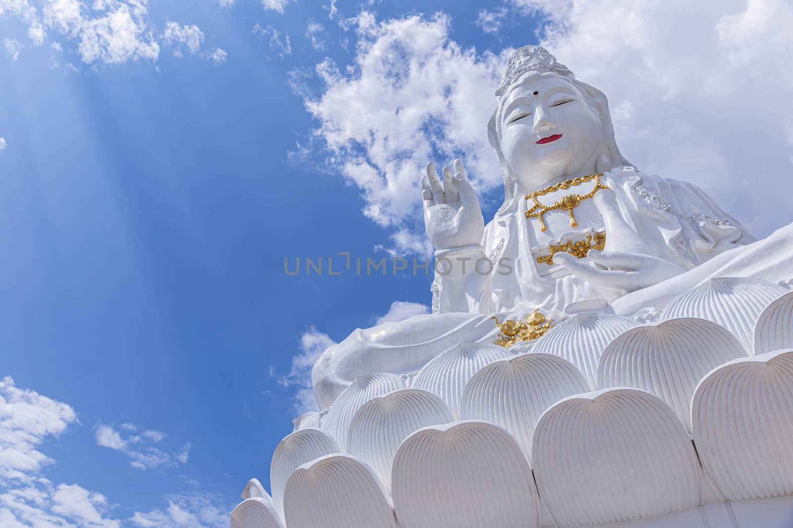 Guan Yin statue with blue sky and clouds sky. by phanthit