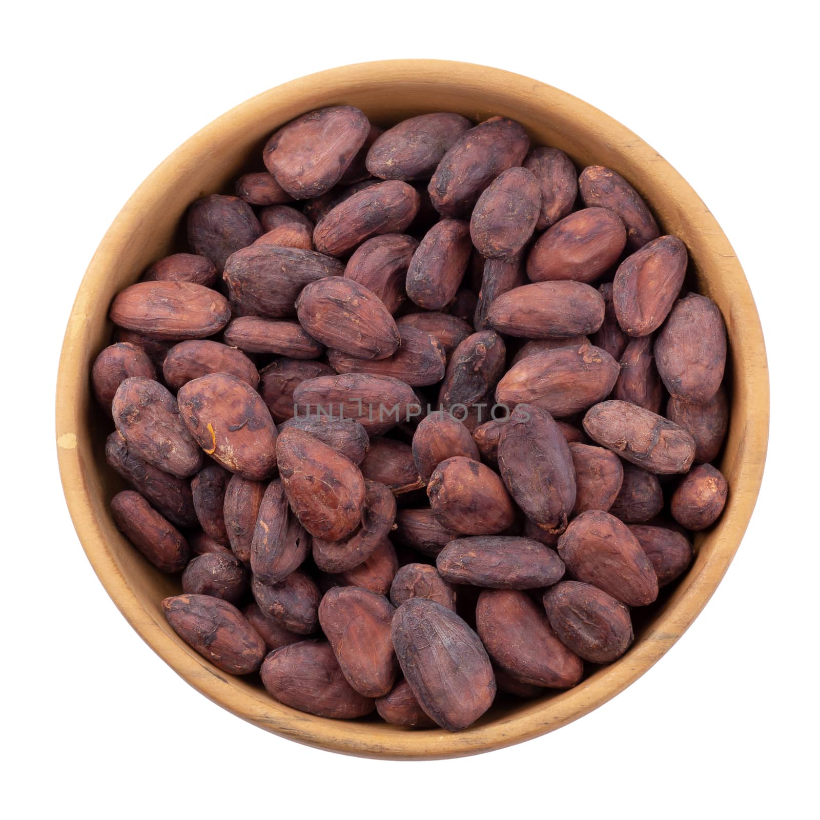 Cocoa fruit in a wooden bowl, raw cacao beans isolated on a white background.