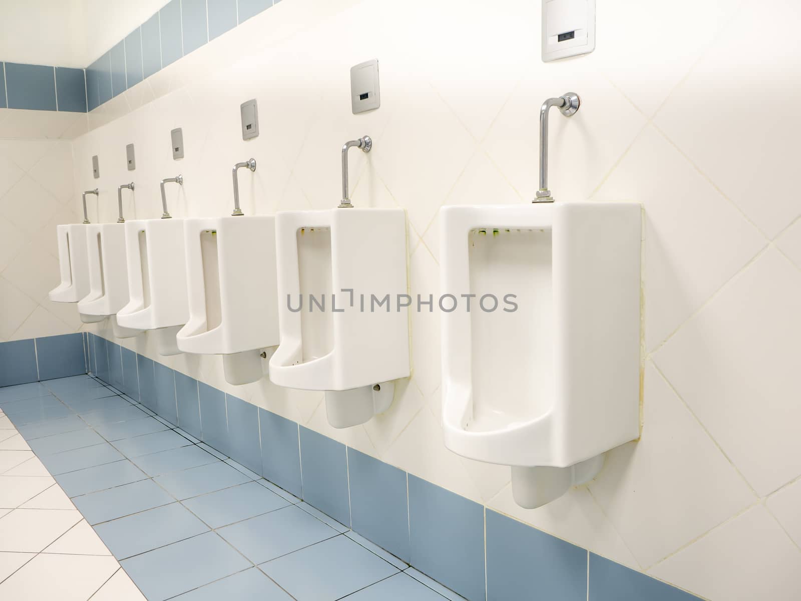 a clean new public toilet room empty by shutterbird