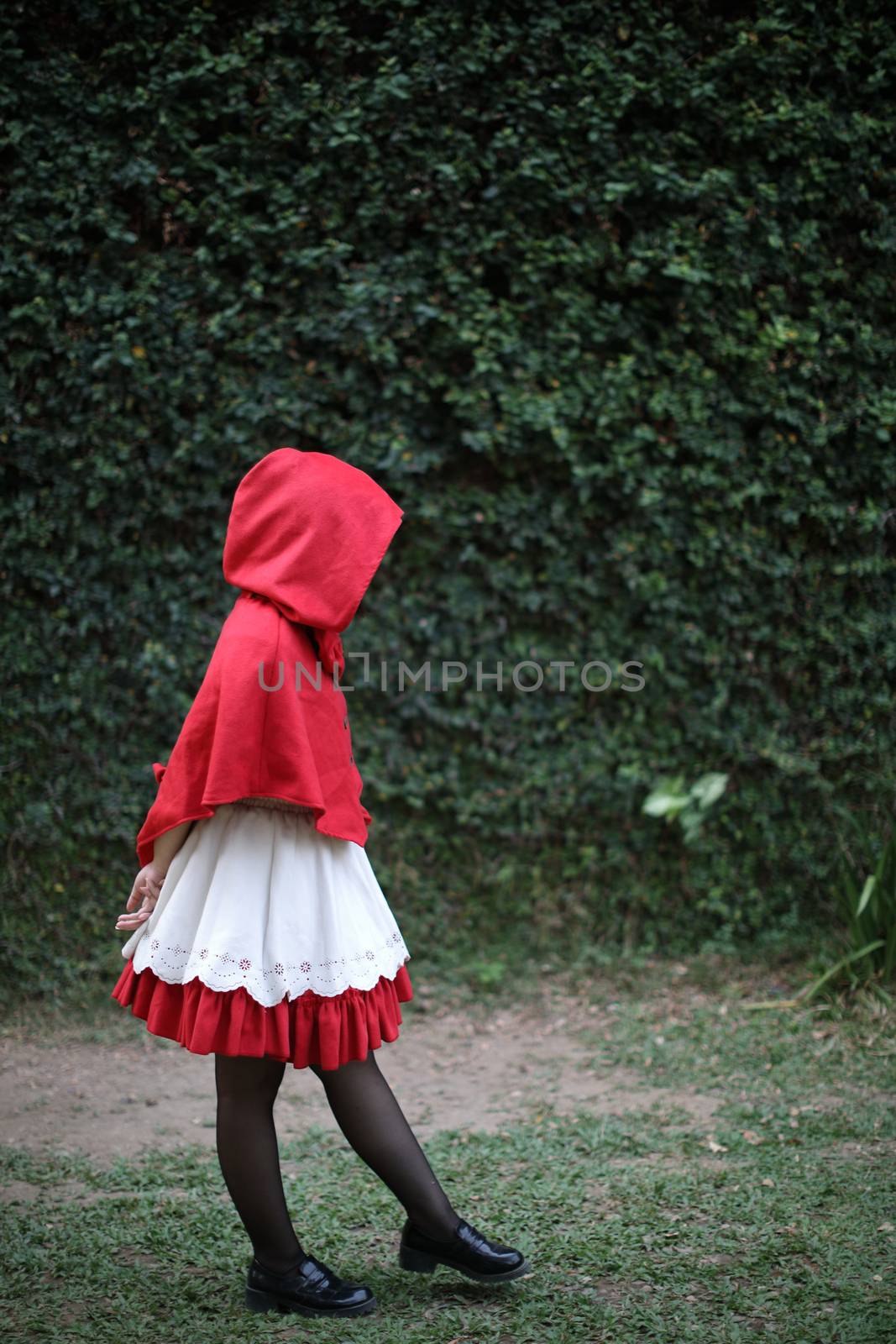 Portrait young woman with Little Red Riding Hood costume with ap by piyato
