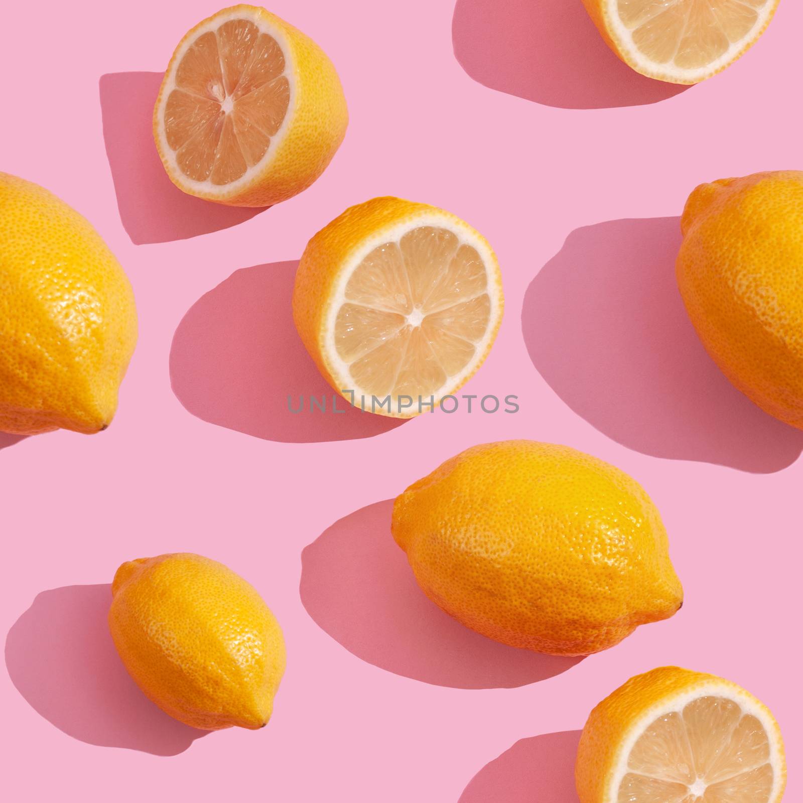 Seamless continuous pattern of yellow lemons on pink background. Minimalist concept of fresh citrus fruit by polyats