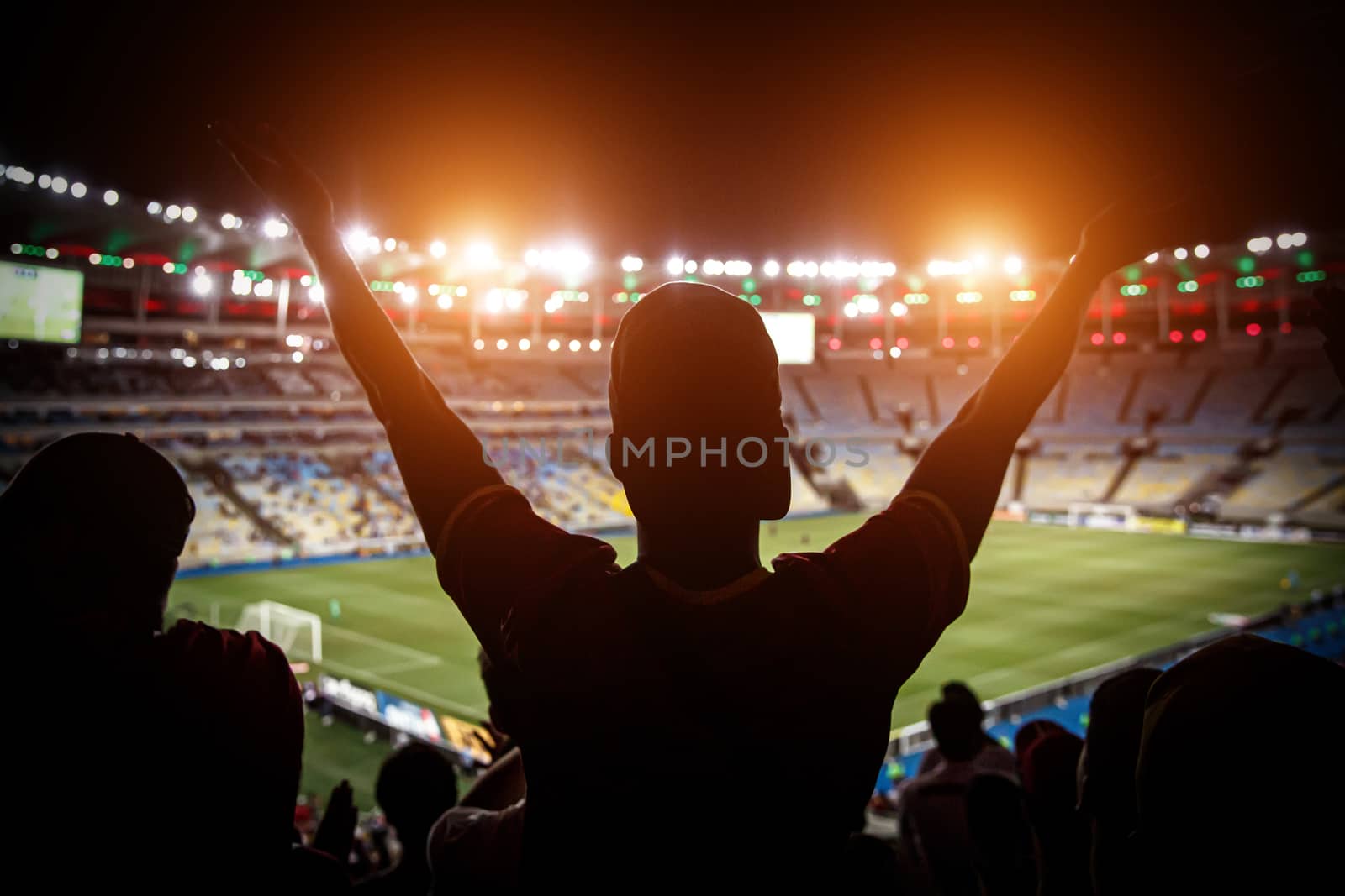 Football fans support team on crowded soccer stadium. by 9parusnikov