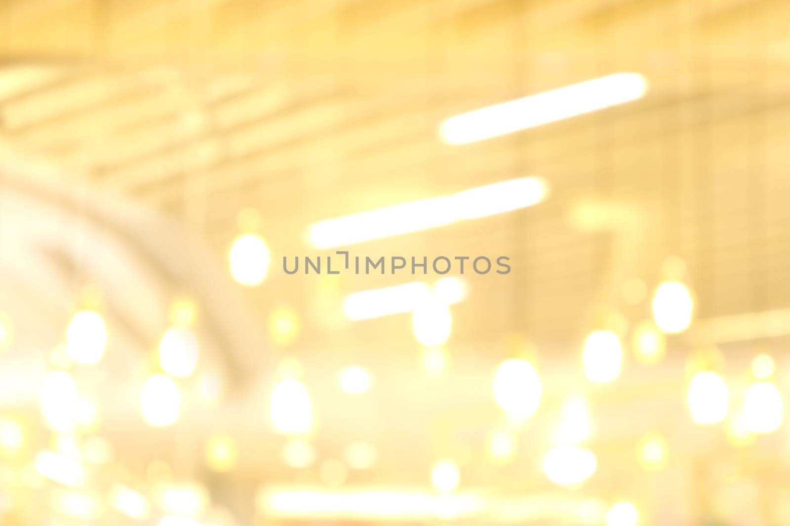 blurred light yellow gold bokeh Inside the mall luxury for background, bokeh golden abstract light shine background blur