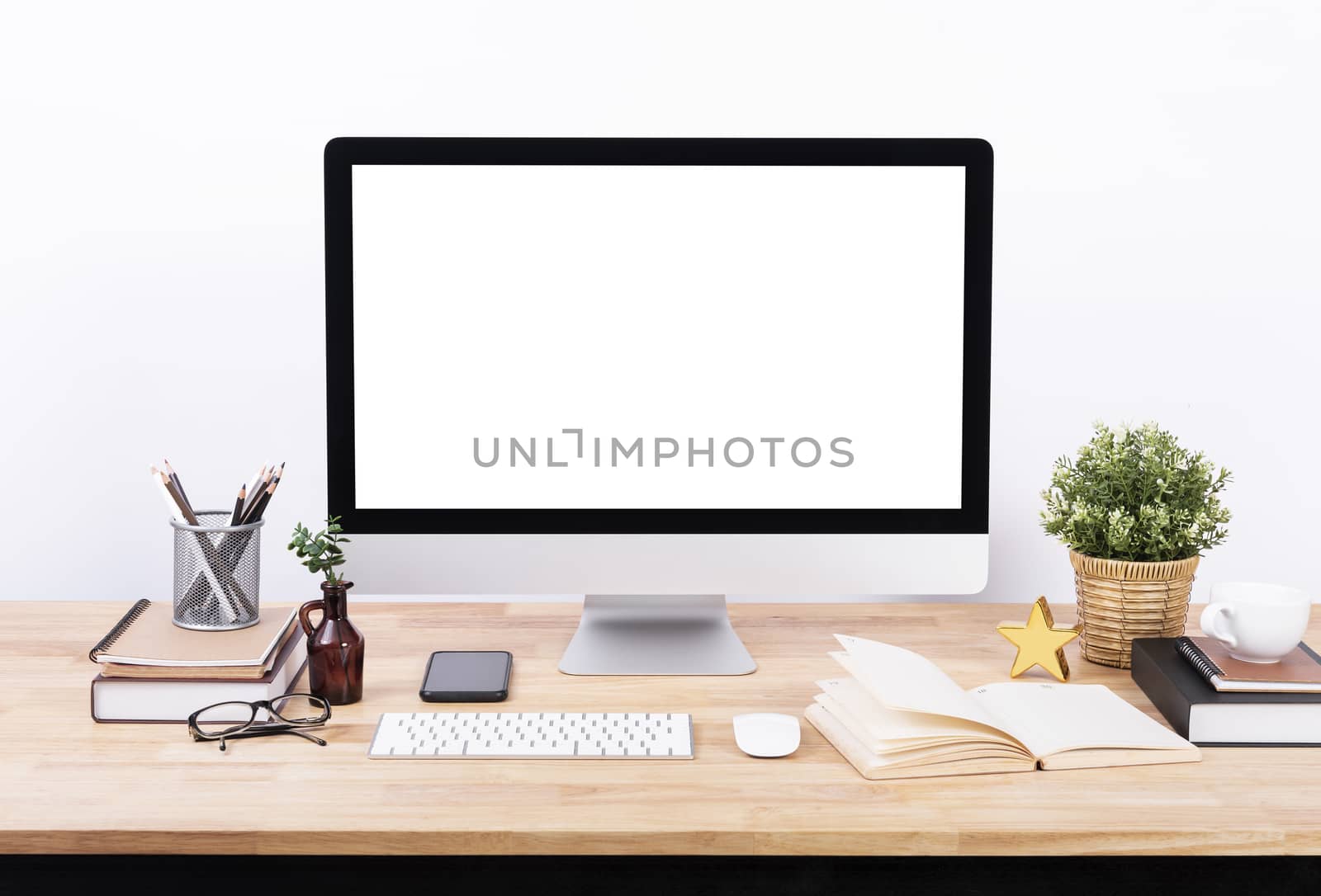 Mockup Blank screen desktop computer and decorations on wood table and white wall background. by barameeyay