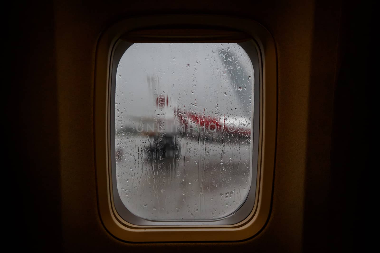 Raindrops on the window glass of an airplane by 9parusnikov