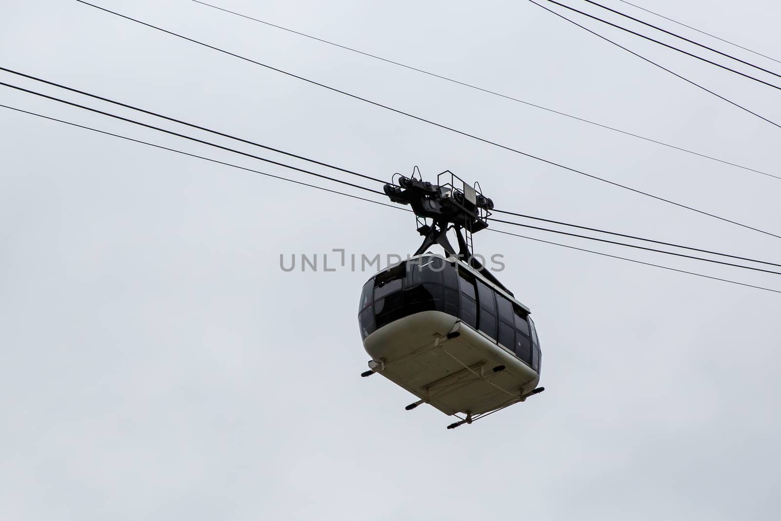 Cabin cableway on a background of cloudy sky. by 9parusnikov