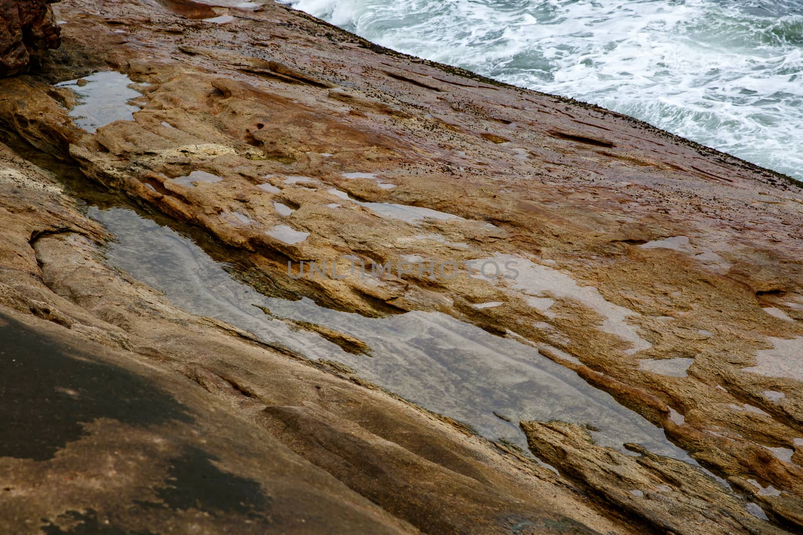 Texture of coastal old stone. Rock wallpaper