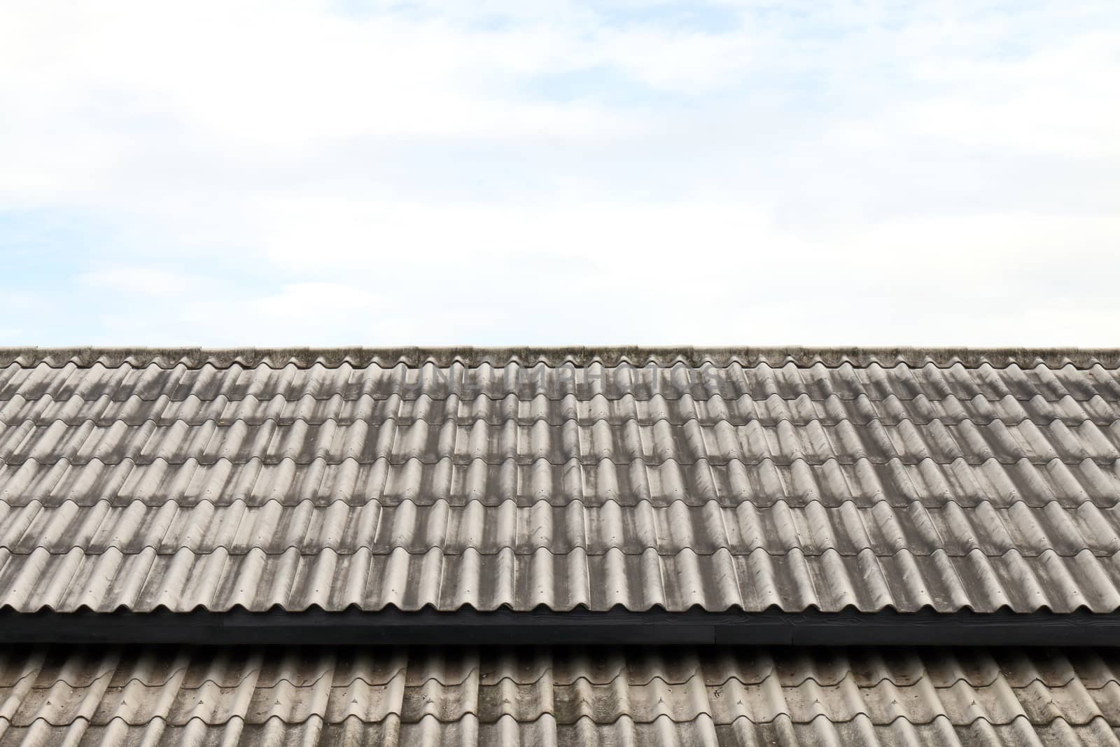 roof wavy tile, roofing tile old, white or grey roofing tile old on sky background