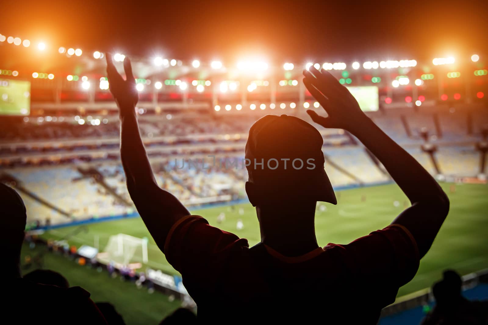 Football fans support team on crowded soccer stadium. by 9parusnikov