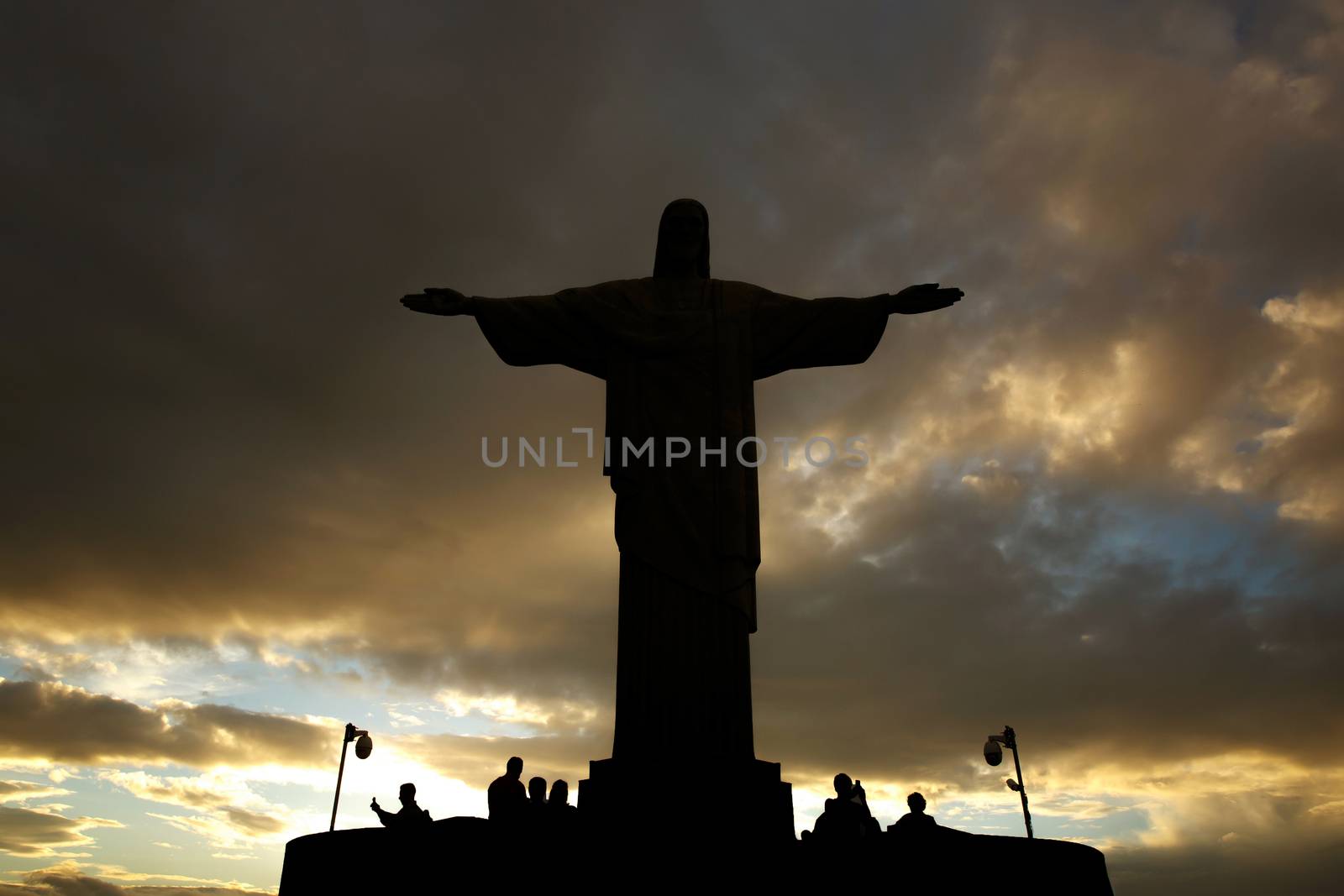 Rio de Janeiro, Brazil - 21.11.2019: Black silhouette of Christ statue. Cross on sunset sky by 9parusnikov