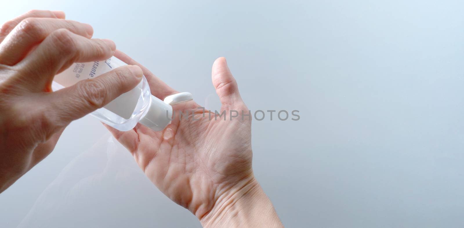 Using a bottle of hand sanitizer against viruses. by maramade
