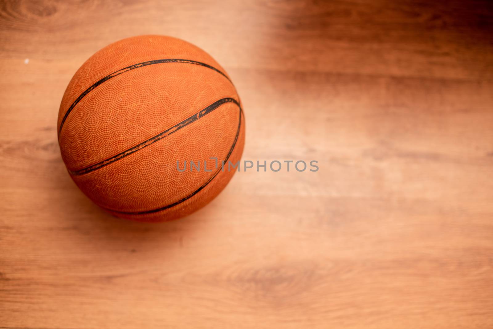 Basketball against hardwood floor shot from above  by rushay