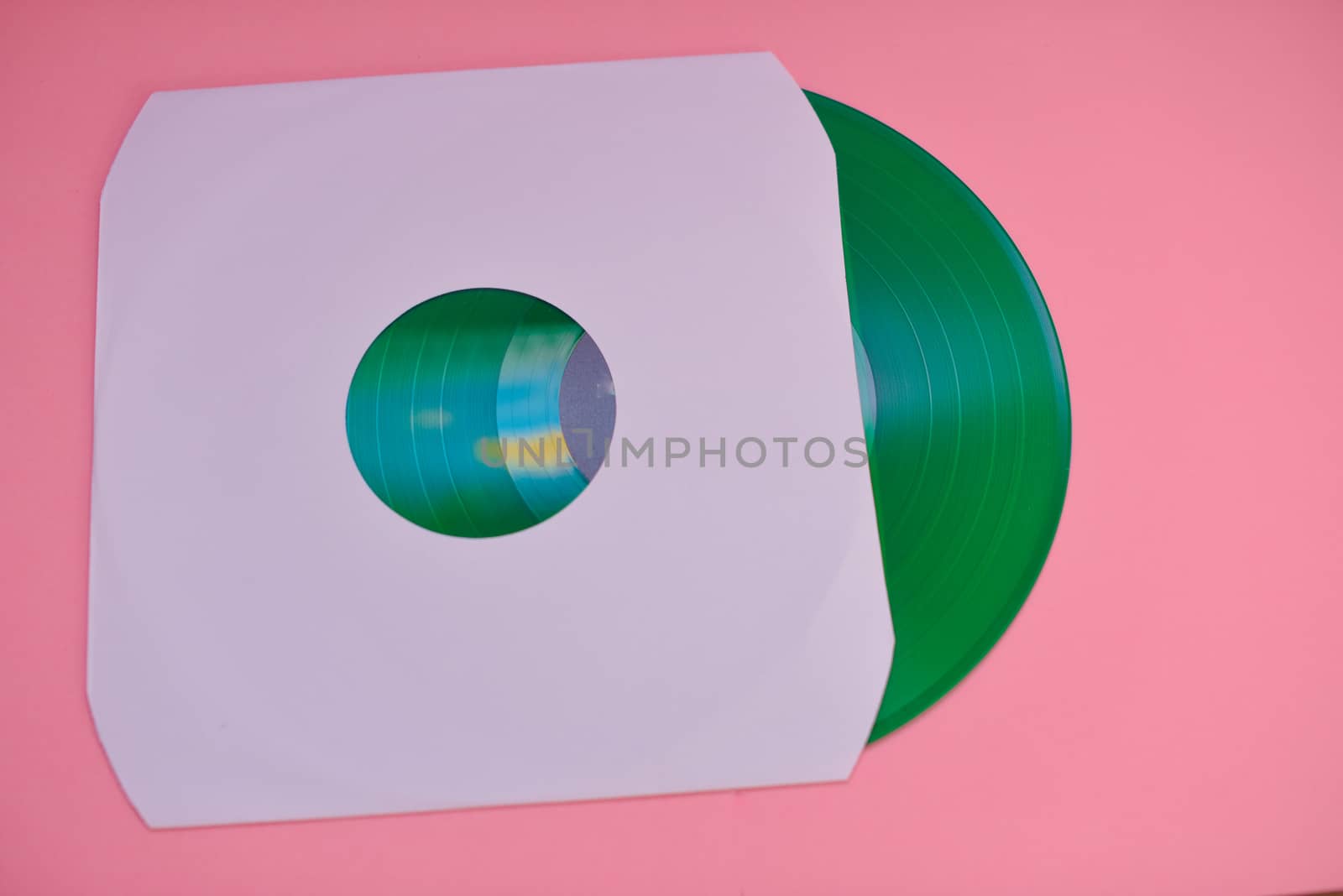 Vinyl record in sleeve isolated against pink background by rushay