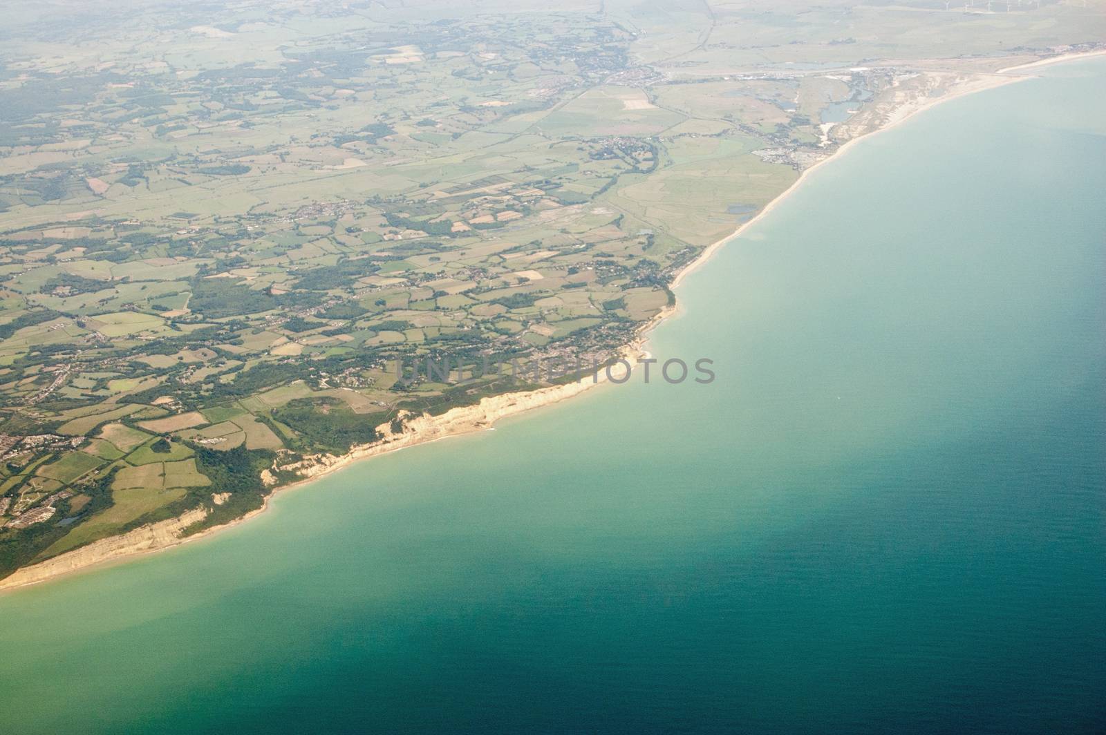 Aerial view of the coast at Sussex with Fairlight in the foreground stretching to Winchelsea and Camber Sands in the distance.  